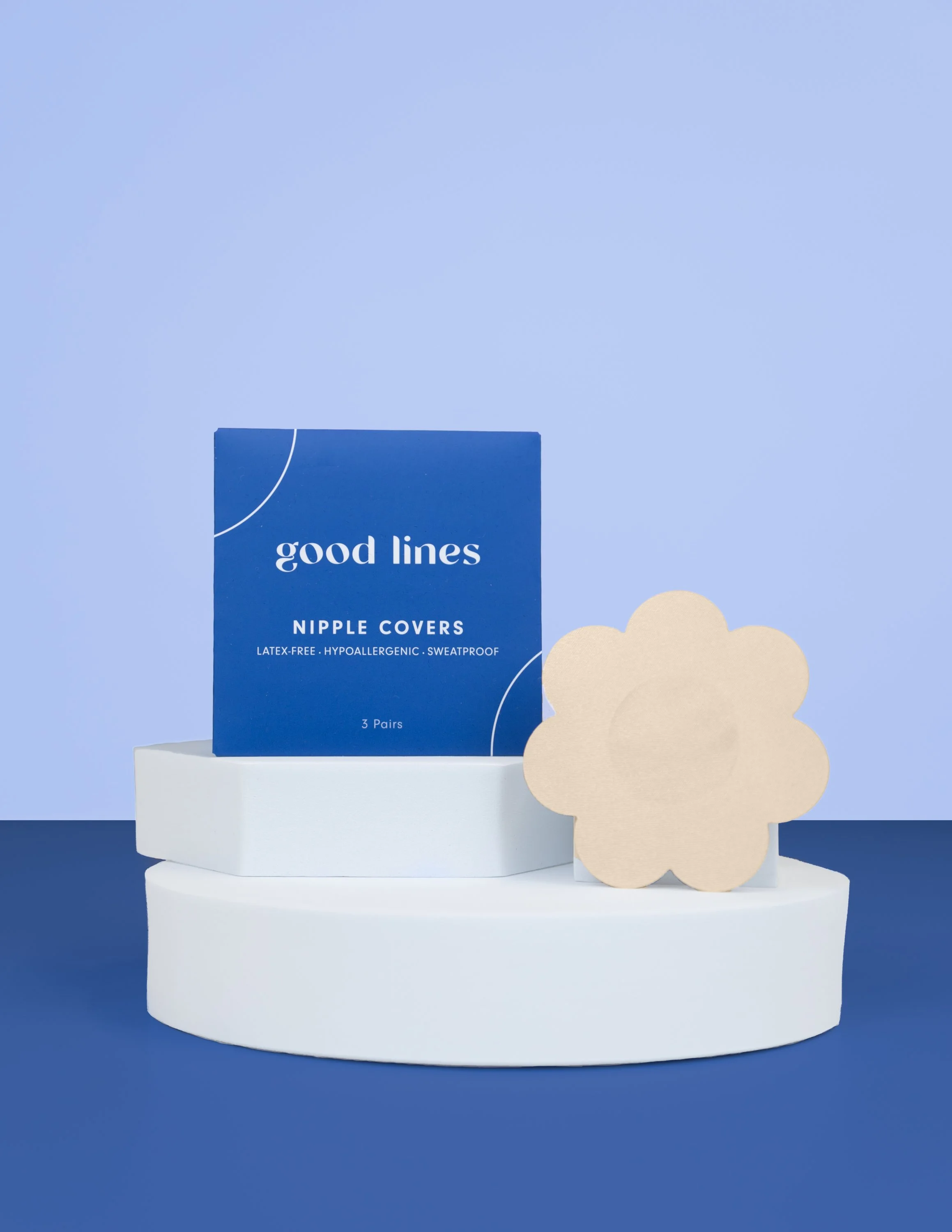 Box of good lines nipple covers with beige flower-shaped covers displayed on white and blue platforms.