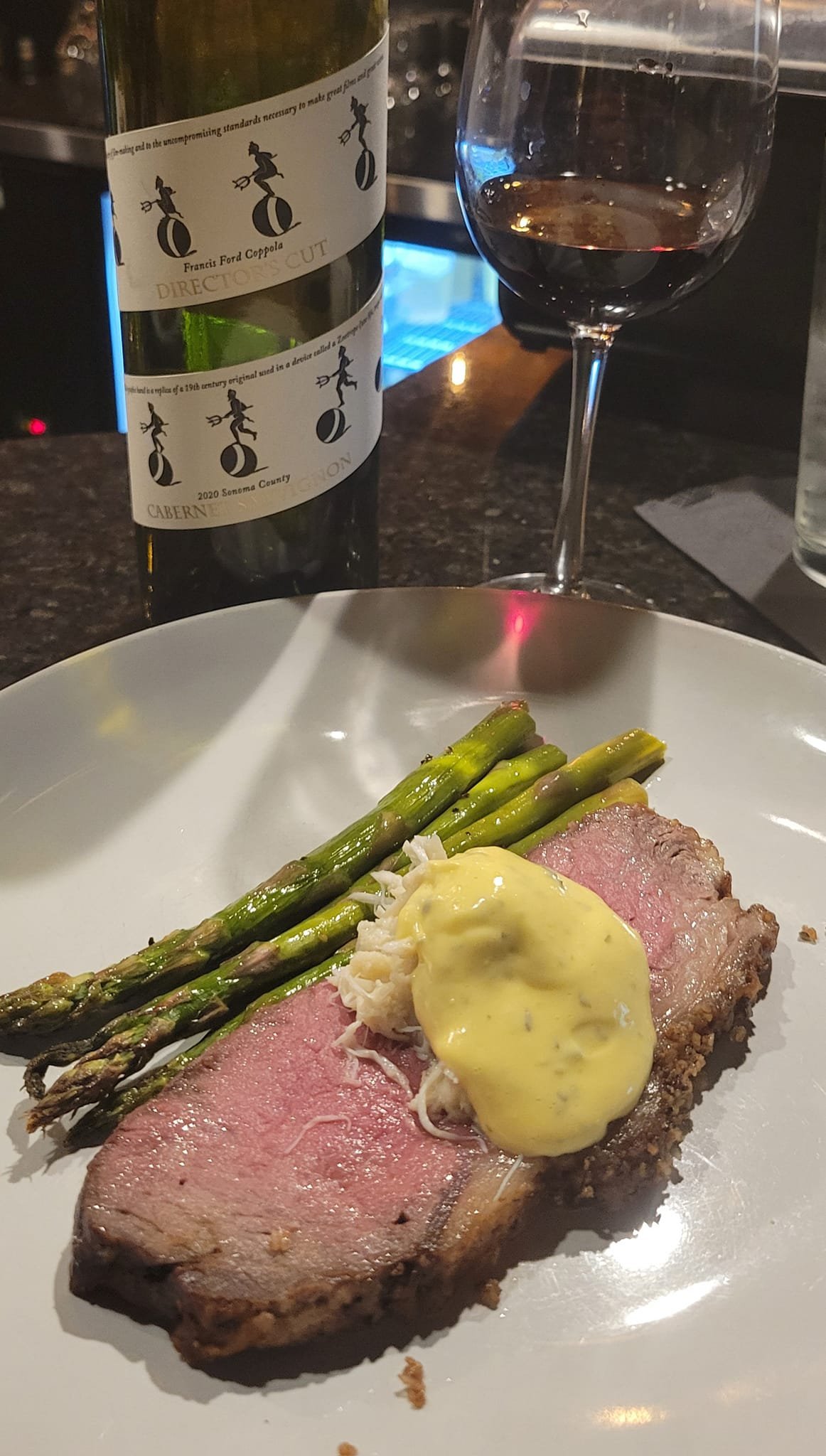 carved strip steak topped with lump crab and béarnaise sauce served with asparagus