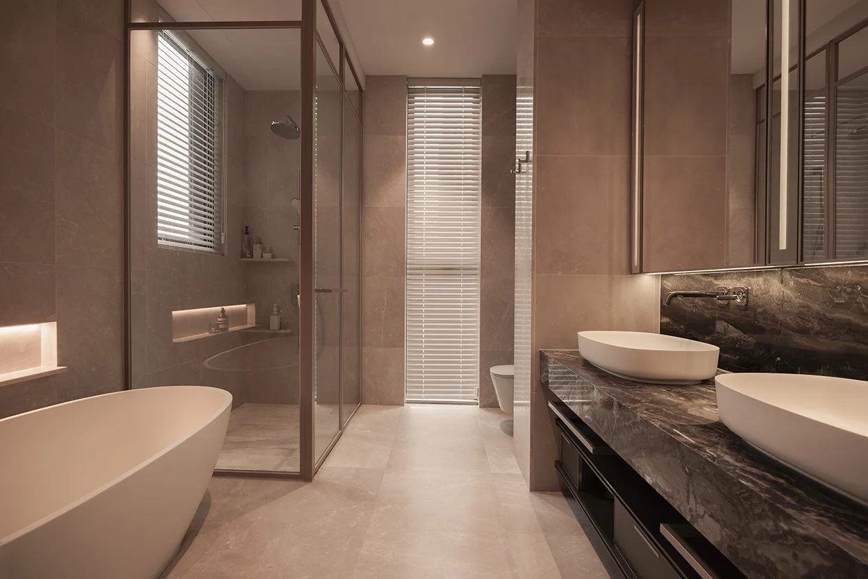Modern bathroom with a bathtub, a walk-in shower, double sinks, and beige tiles.