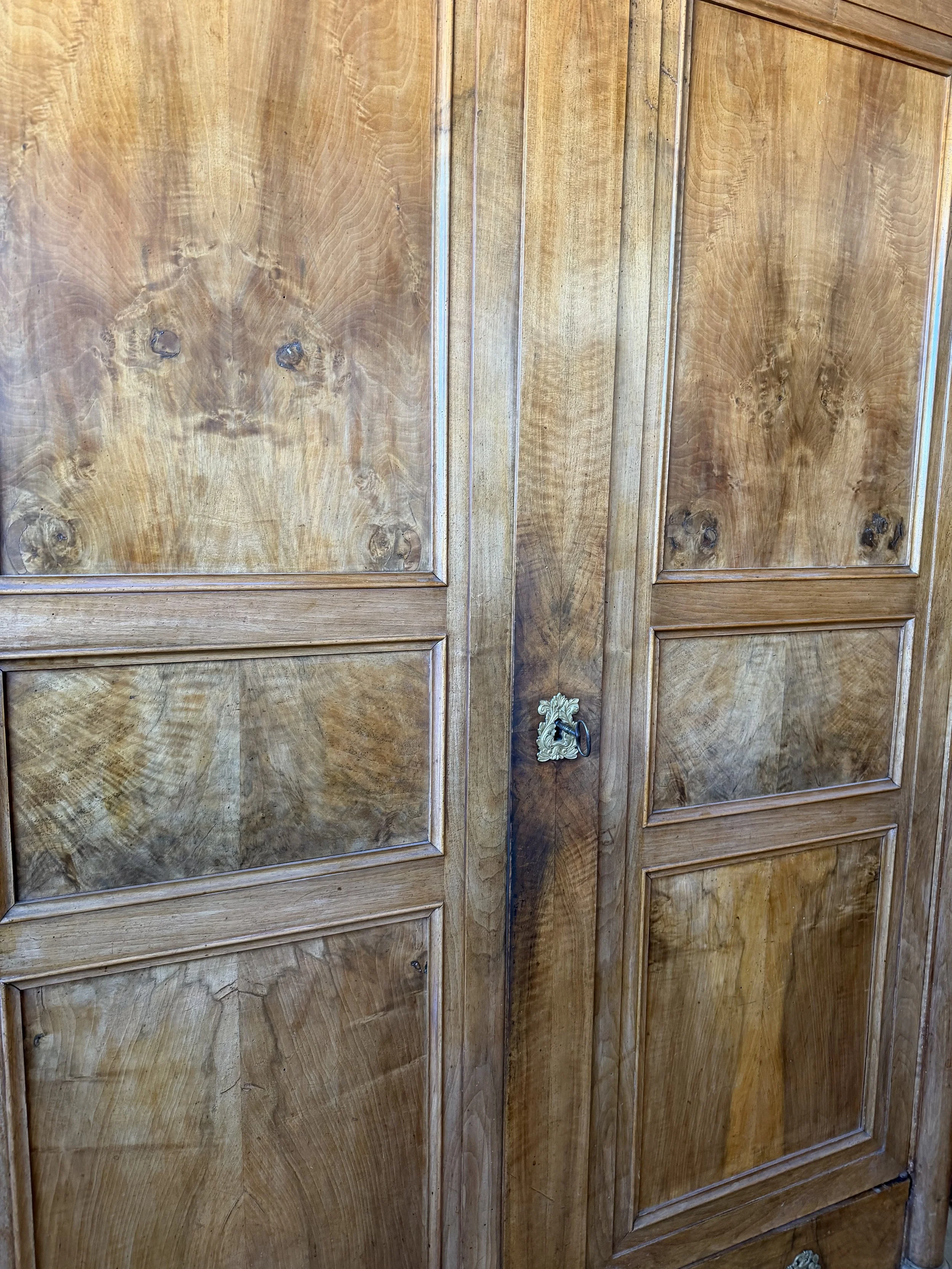 This is a picture of a fabulous French Empire walnut cupboard c1830 with the most beautiful colour and original hardware.