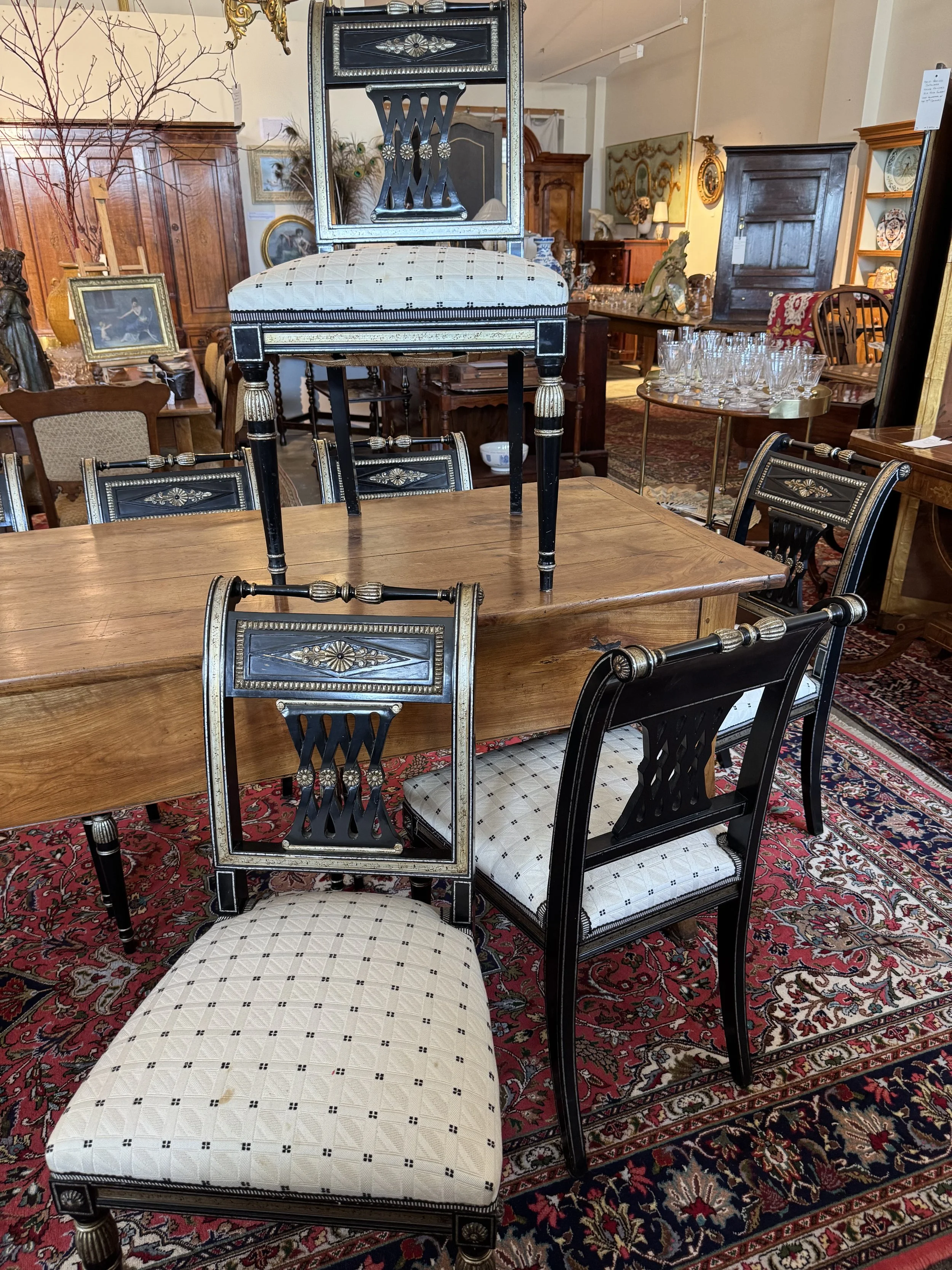 This is a picture of a set of eight French black Japanned and lacquered silver chairs in the Directoire style very much in the manner of Maison Jansen c1950.
