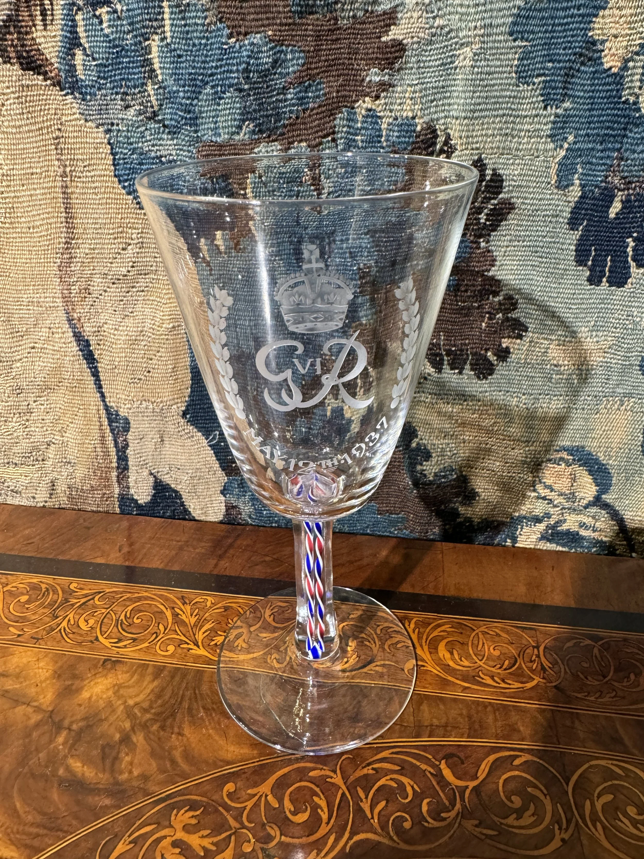 This is a picture of a fine and rare George VI Webb & Co engraved and enamel twist stem glass made for the 1937 coronation of King George VI, signed to the base.