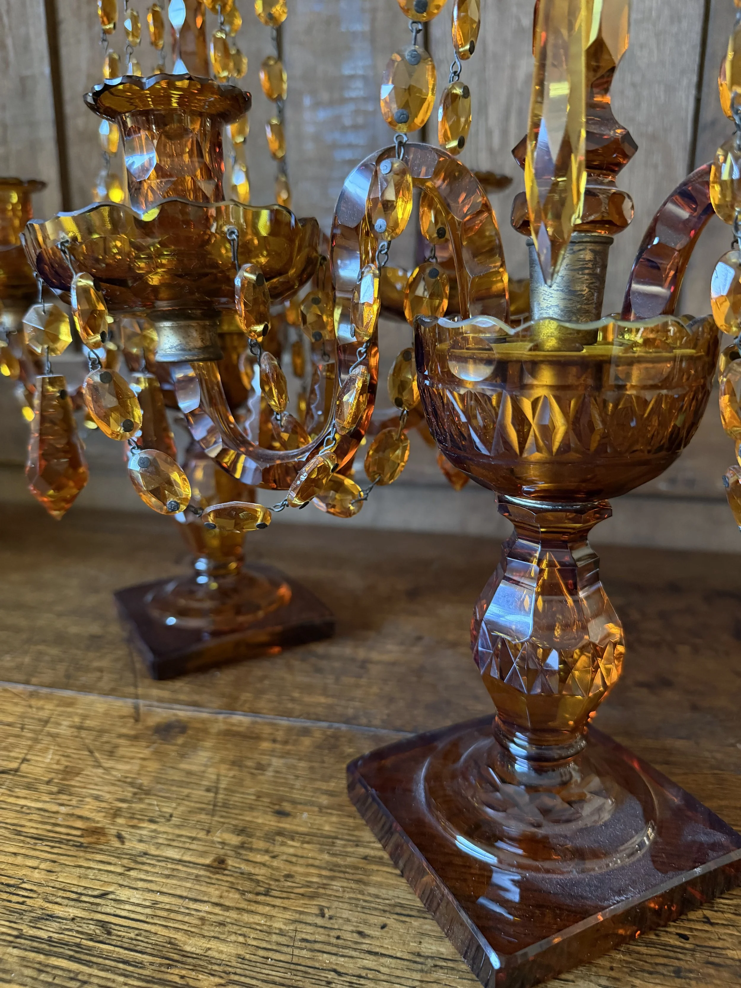 This is a picture of a fabulous pair of Edwardian Georgian revival girandoles in amber glass c1900.