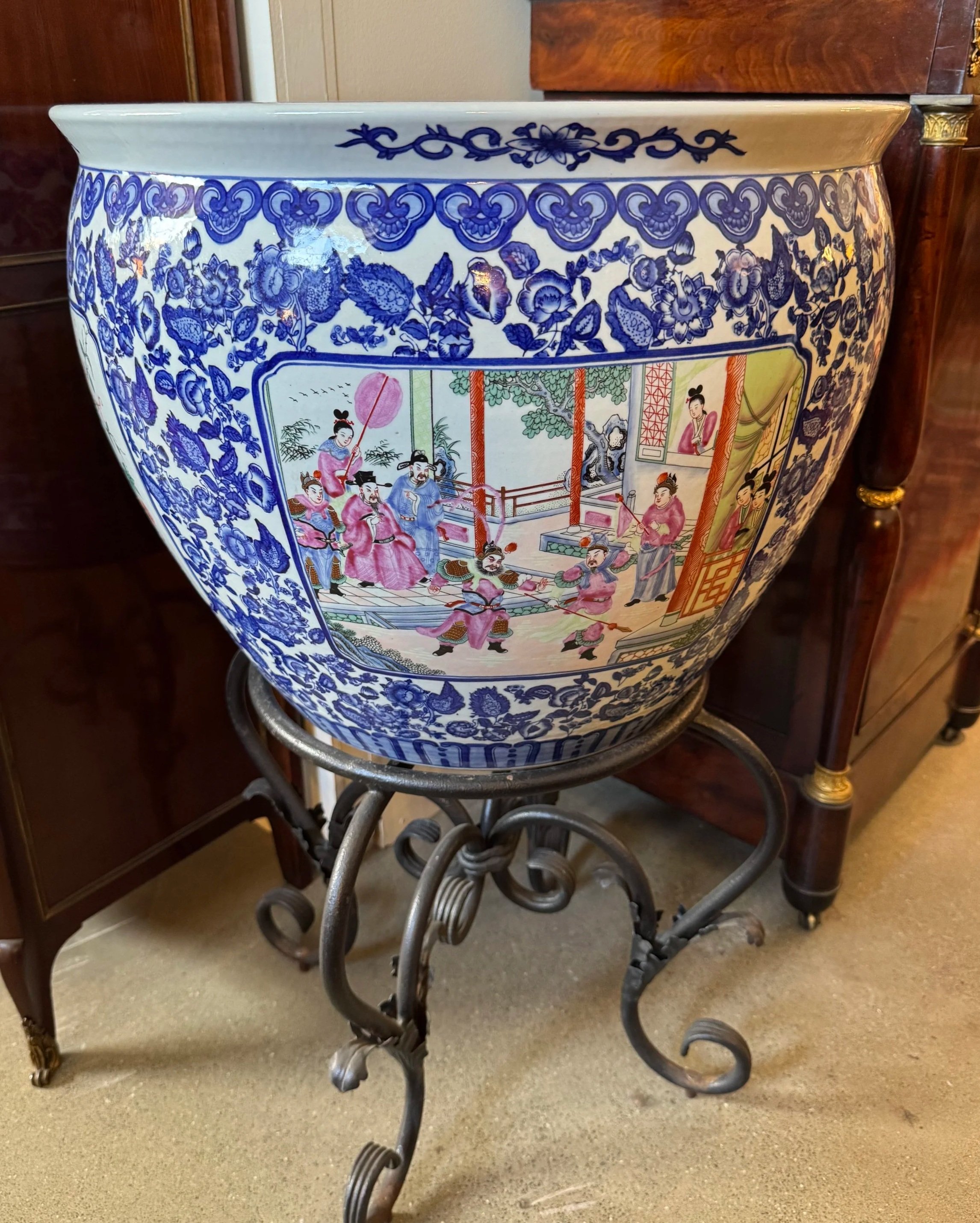 This is a picture of a mid 20th century hand painted Chinese porcelain fish bowl/jardiniere on a wrought iron stand.