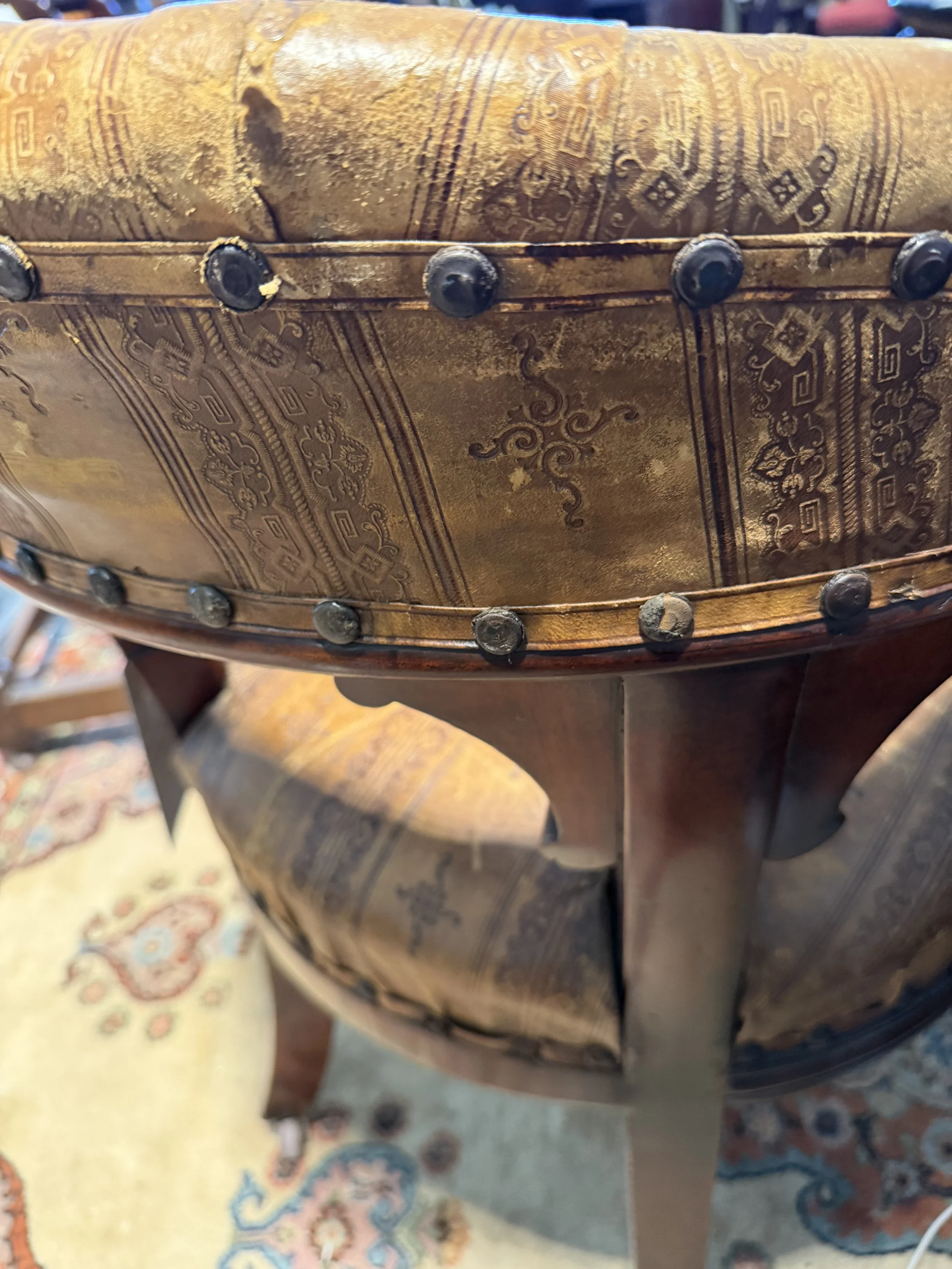 This is a picture of a very handsome and comfortable Victorian mahogany desk chair retaining its original stamped leather upholstery c1870.
