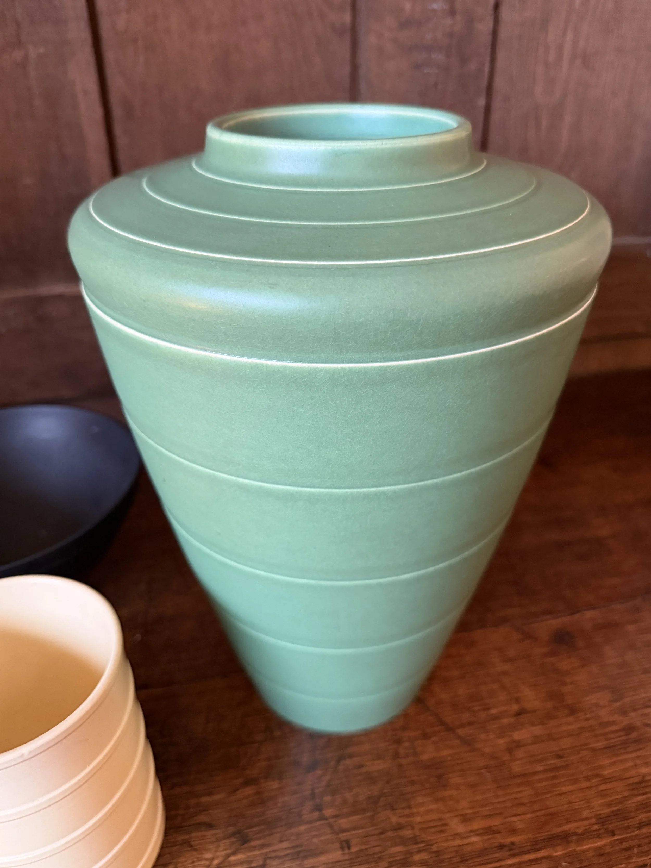 This is a picture of a Keith Murray for Wedgwood Art Deco green coloured vase c1930.