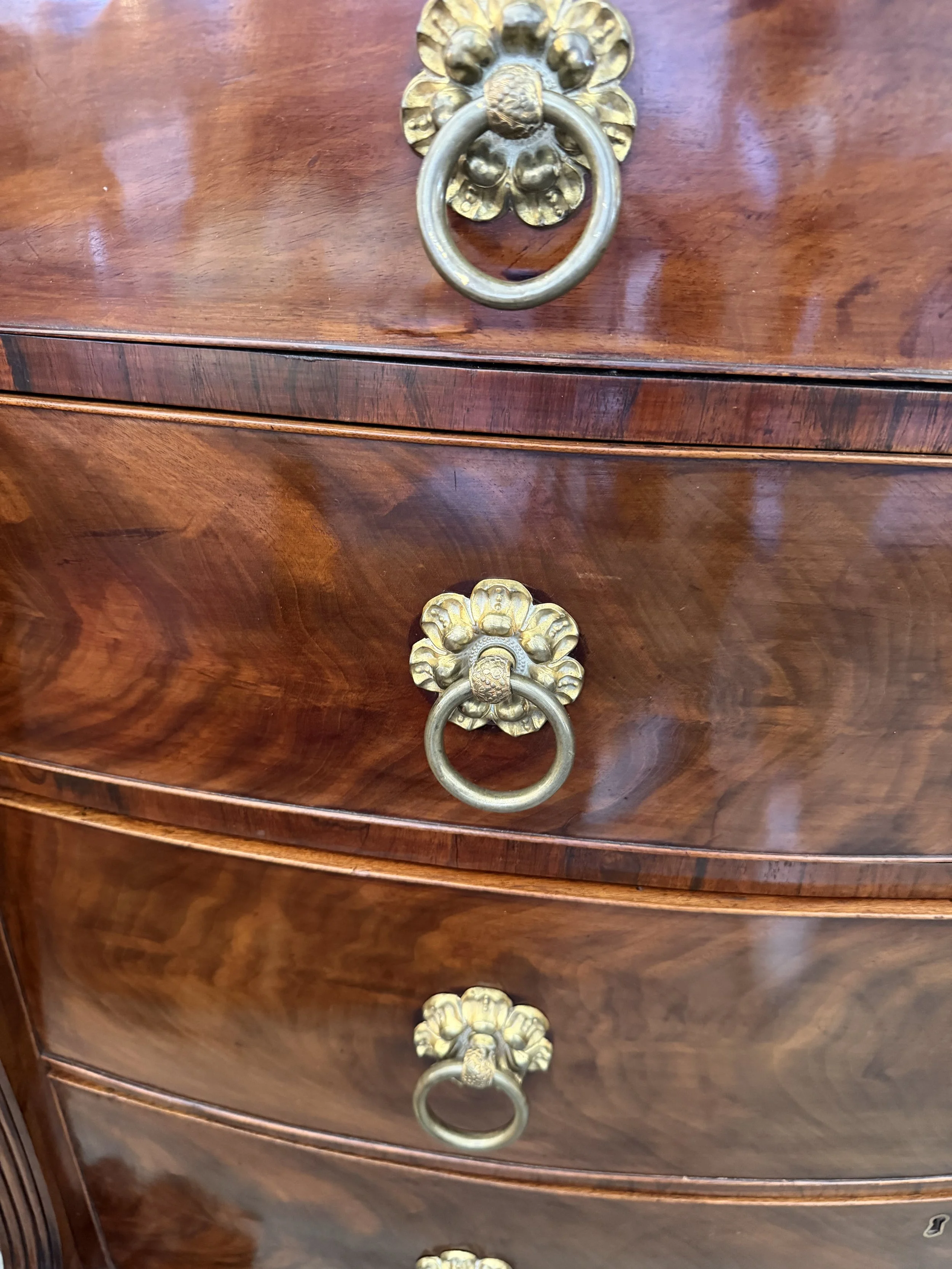 This is a picture of a superb George IV period mahogany bow front chest of drawers retaining it’s original brass ring handles, Channel Islands origin, c1825.