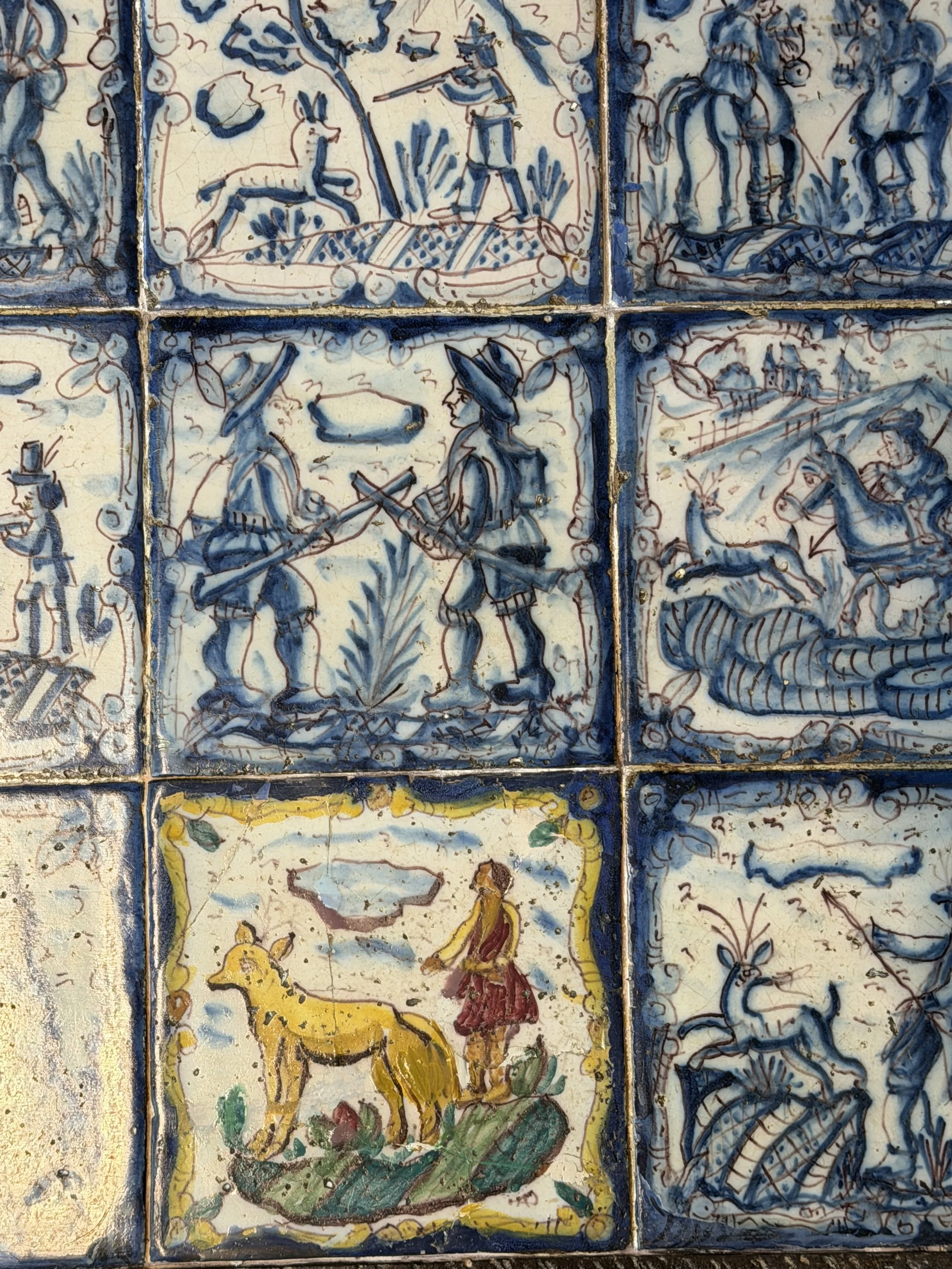 This is a picture of a panel of 20 wonderful 18th century Spanish tiles set into a mid 20th century wrought iron coffee table base.