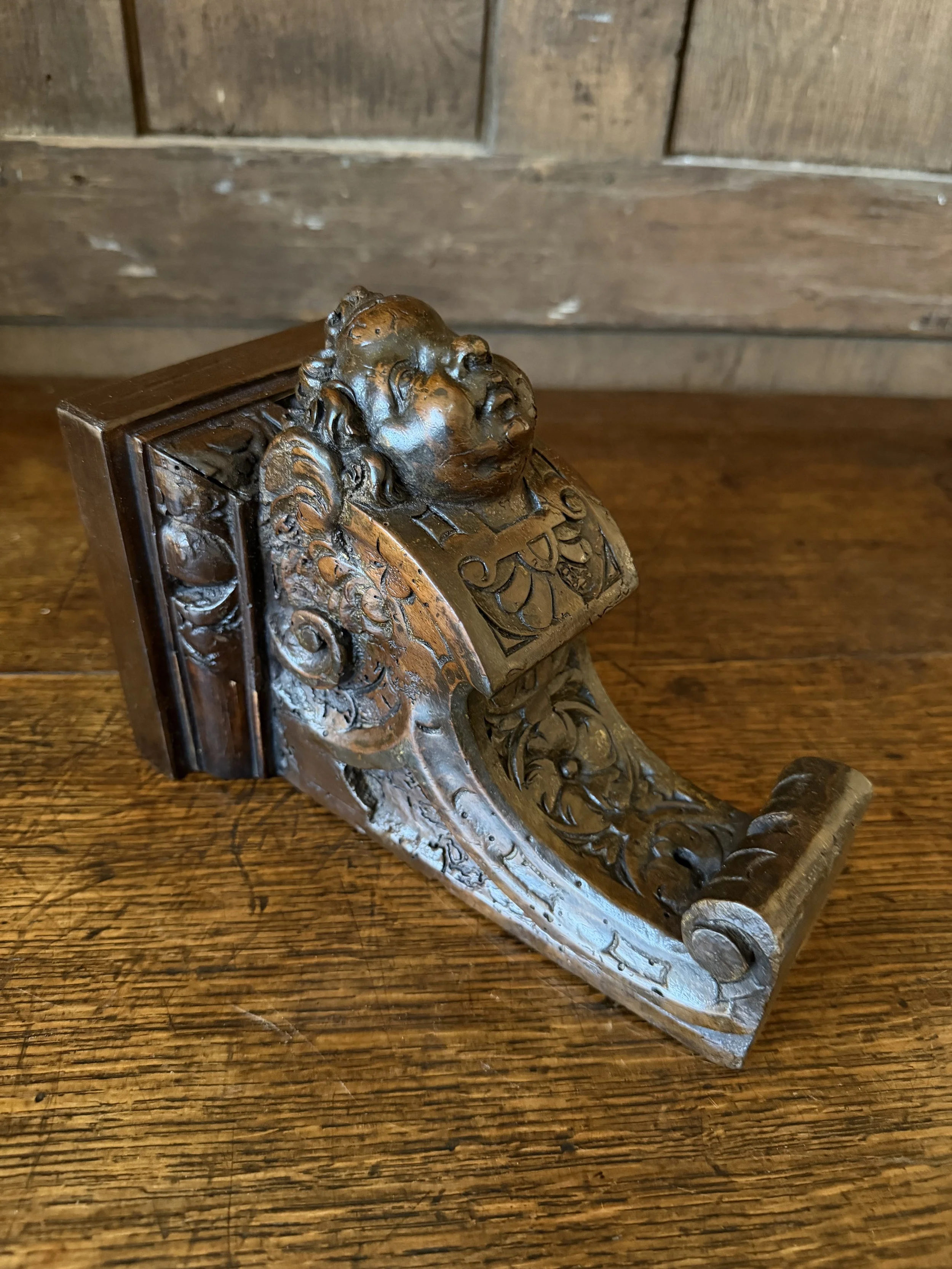 This is a picture of a 17th century Venetian carved walnut bracket in the form of a cherub.