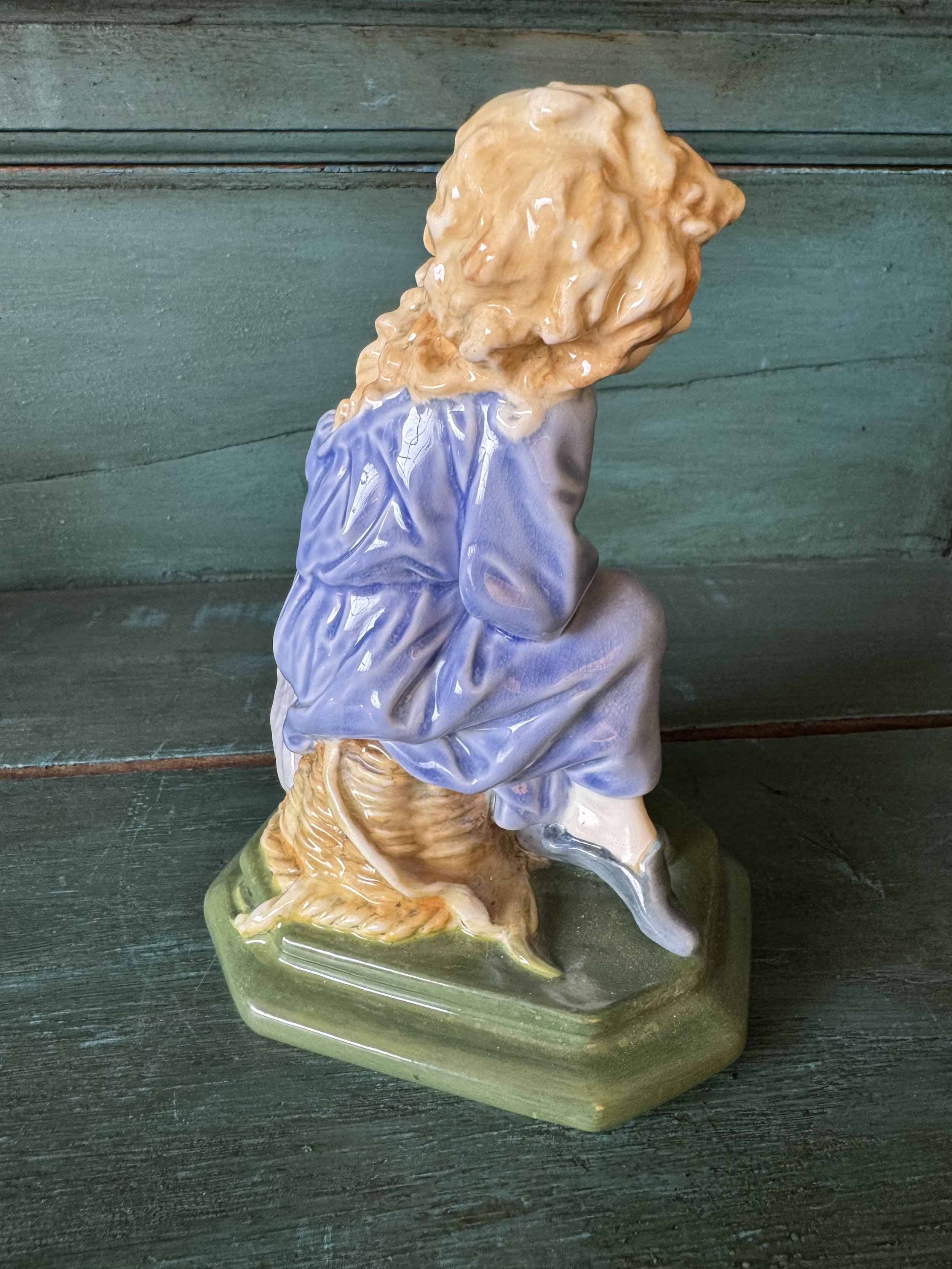 This is a picture of a charming figure designed by William White for Doulton &Co c1915 called The Sleepy Scholar in a rare colour way.