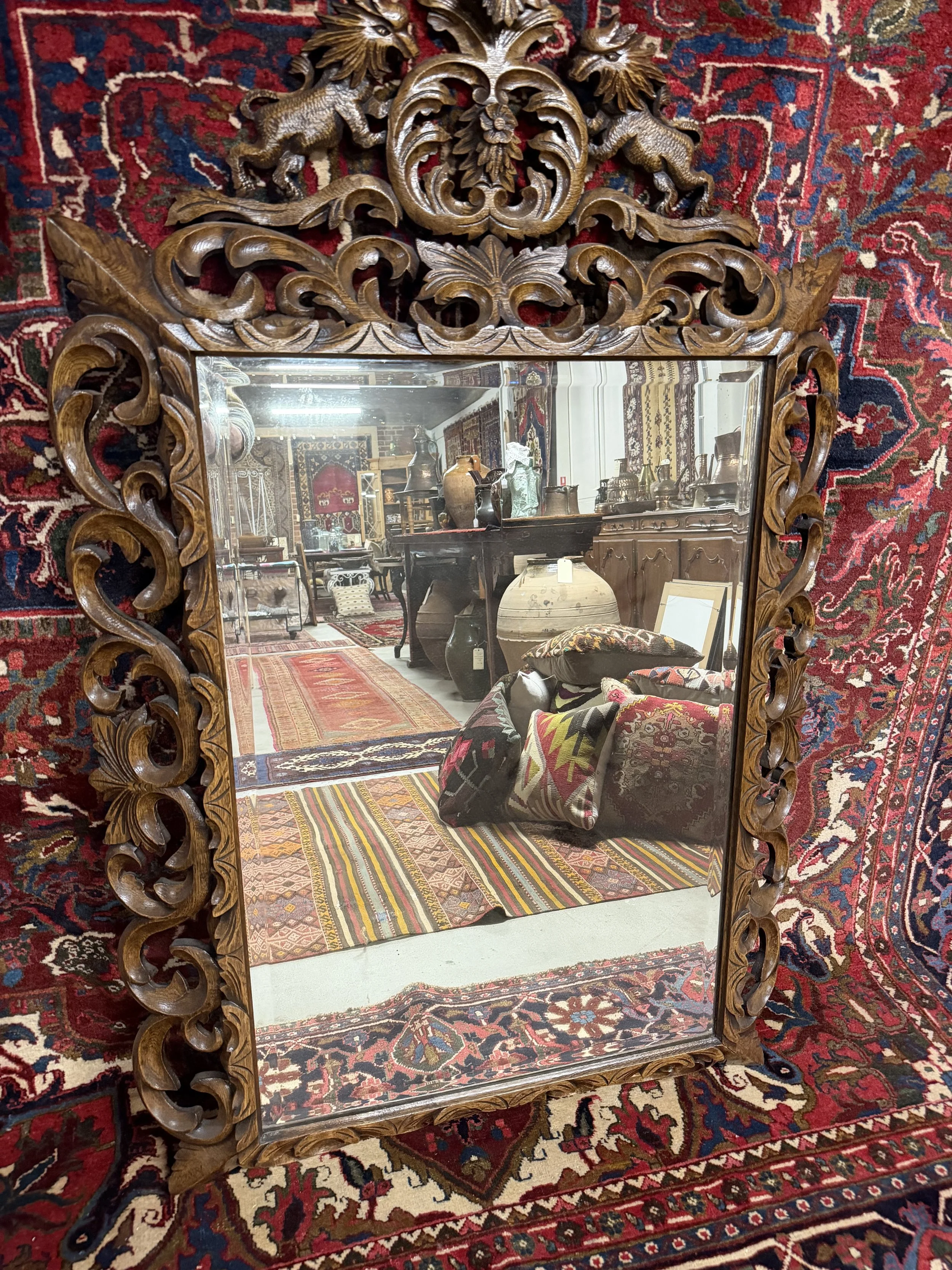 This is a picture of a fabulously carved late 19th century French oak mirror.