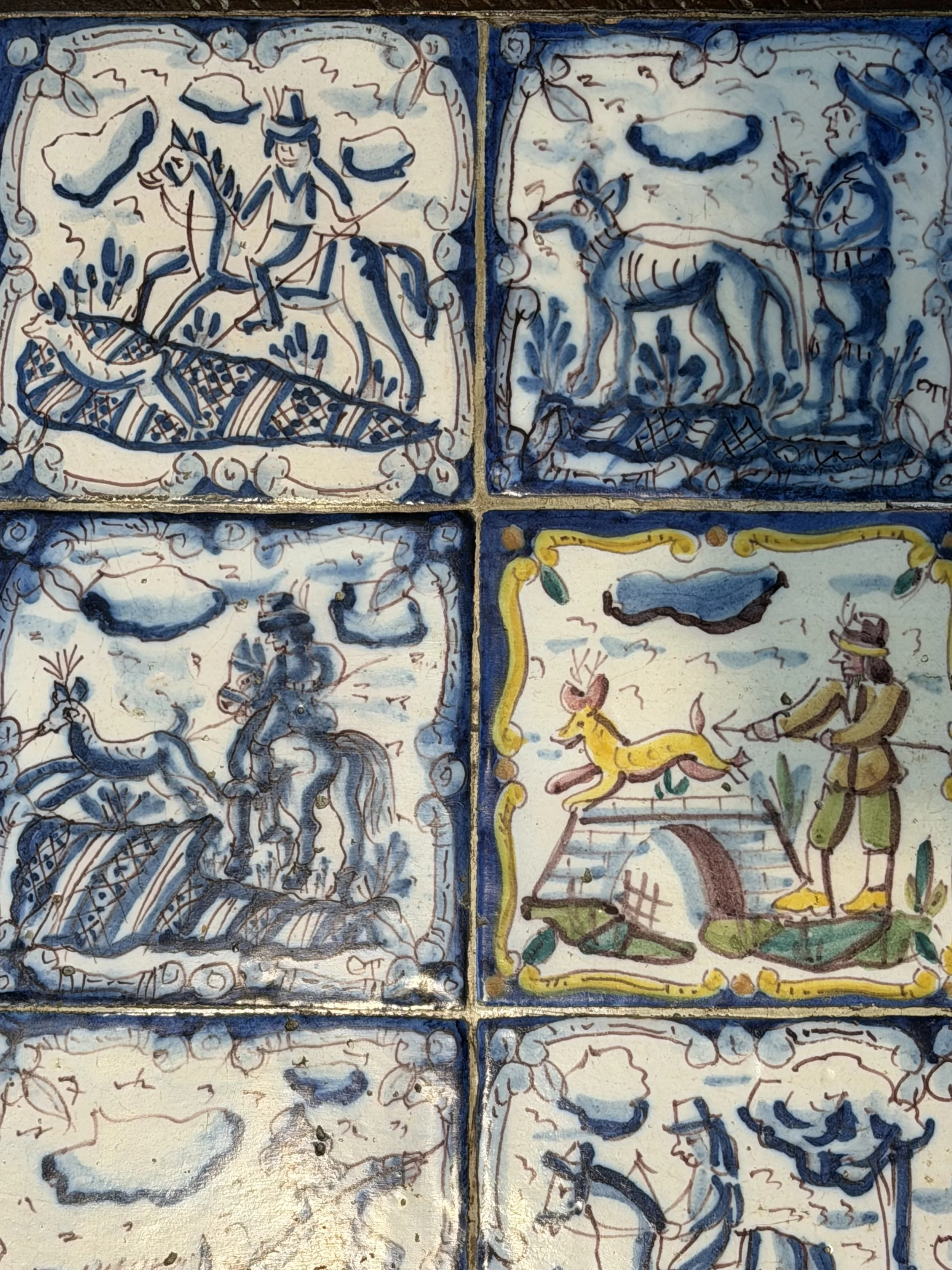 This is a picture of a panel of 20 wonderful 18th century Spanish tiles set into a mid 20th century wrought iron coffee table base.