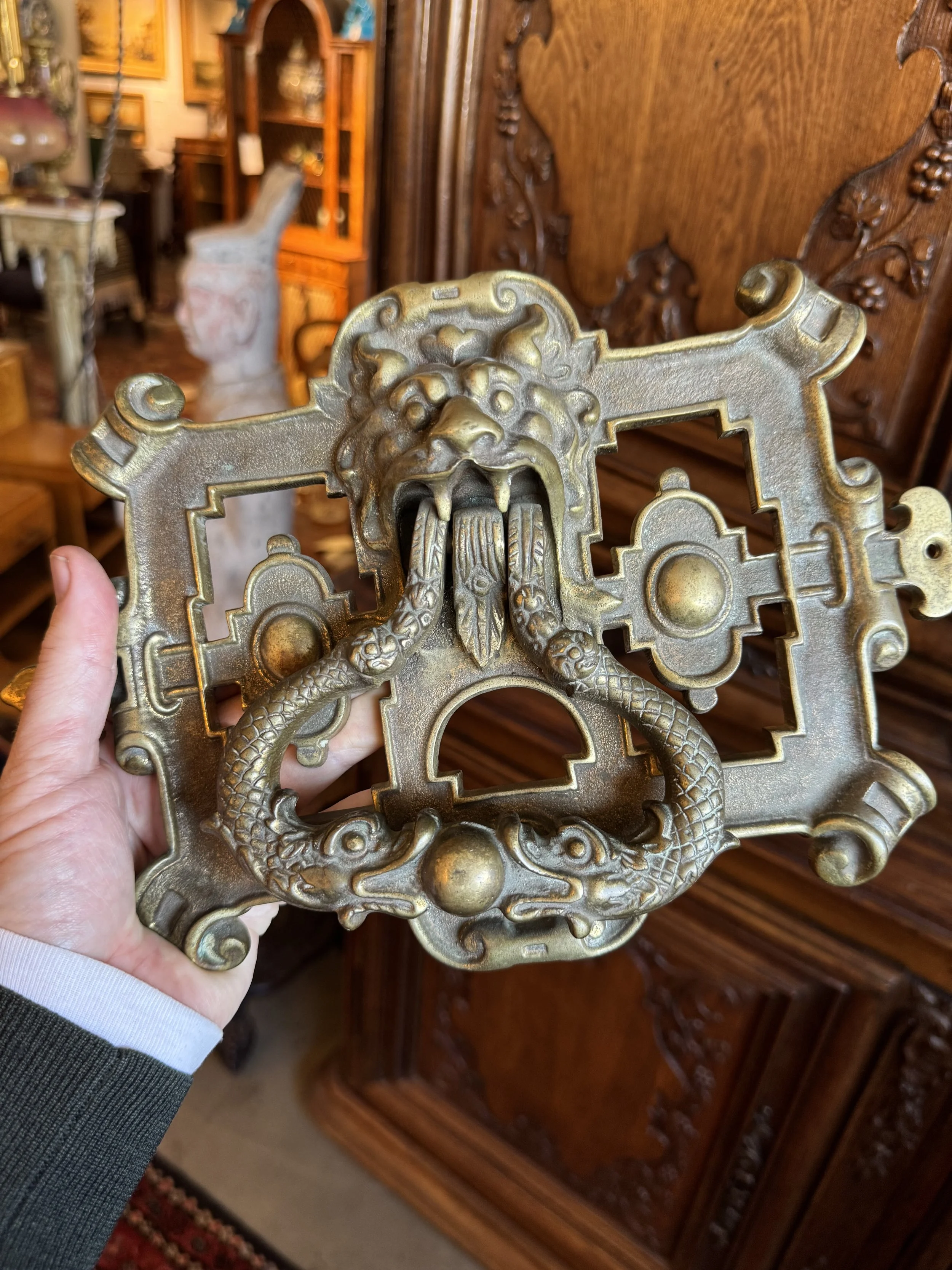 This is a picture of an English mid Victorian cast brass door knocker with lions and dolphins c1870.