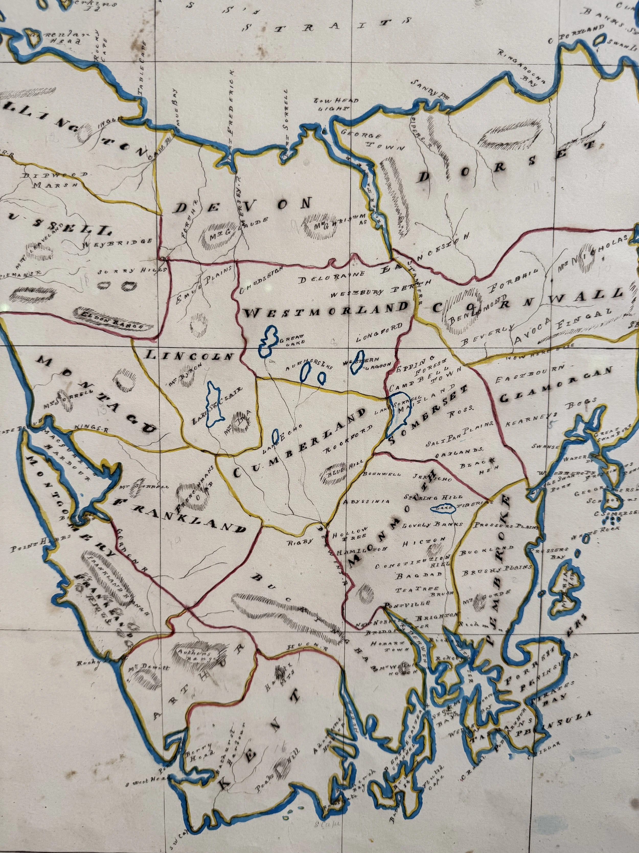 This is a picture of an antique colonial hand drawn and coloured map of Tasmania by William Thomas Travers dated 1862.