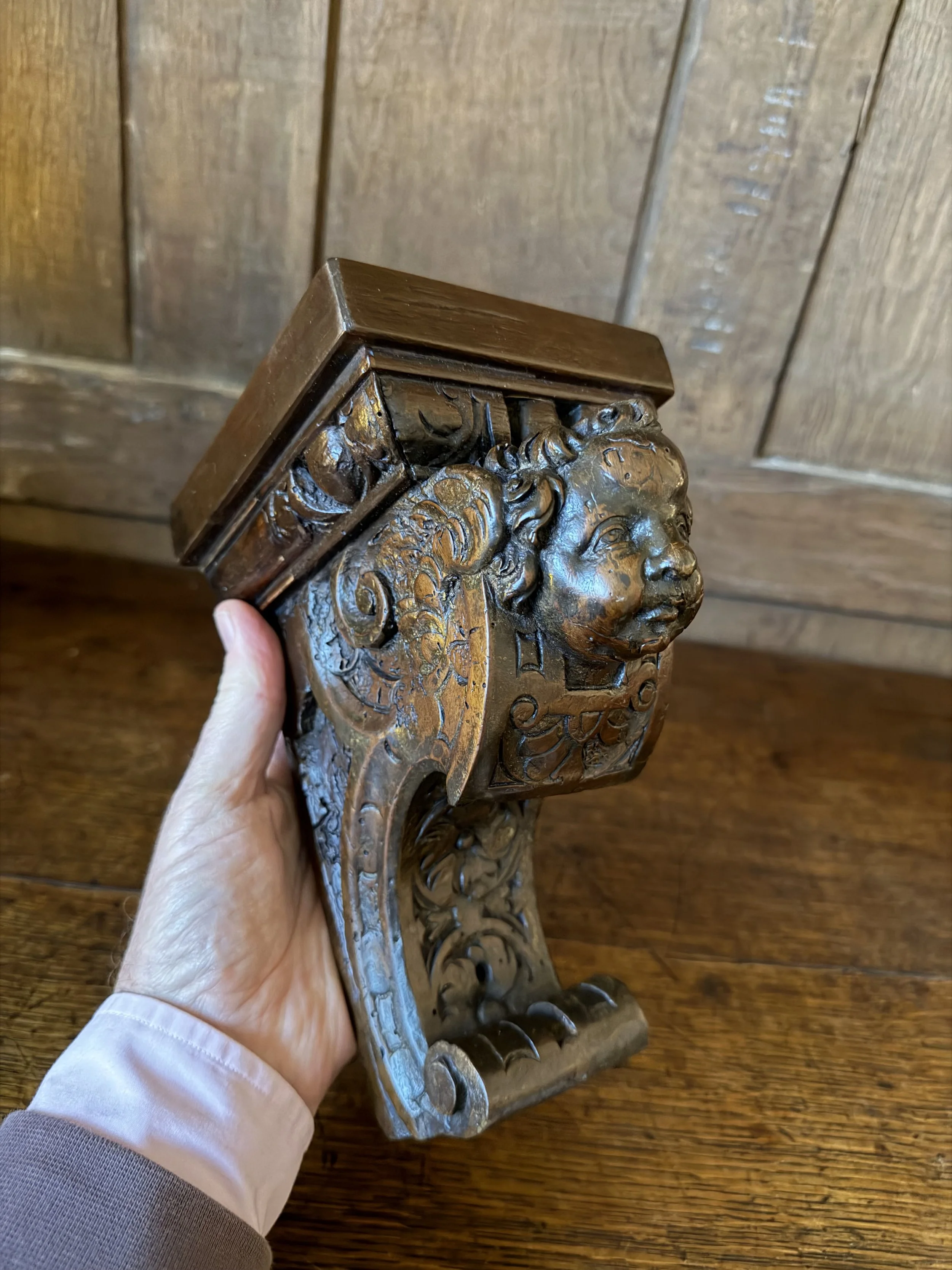 This is a picture of a 17th century Venetian carved walnut bracket in the form of a cherub.