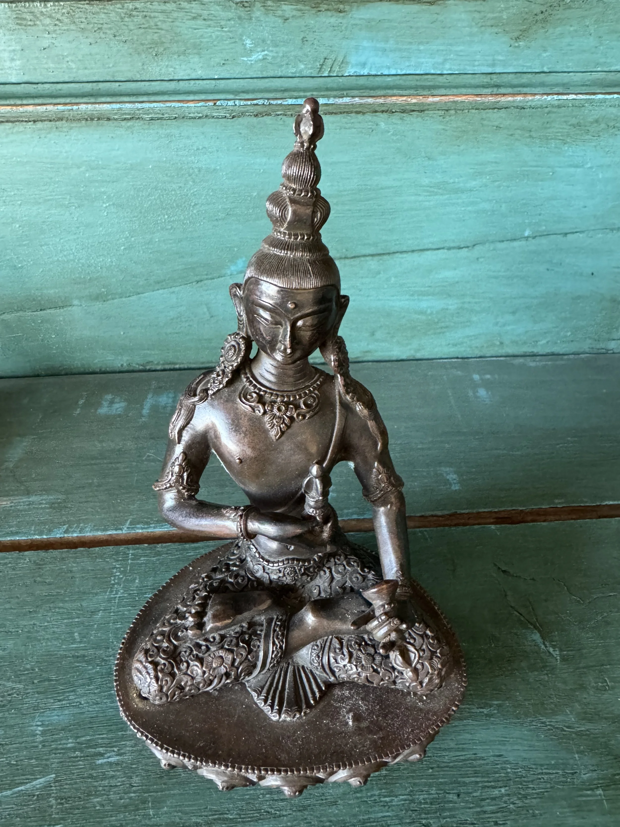 This is a picture of a beautifully patinated late 19th century Nepalese bronze Vajrapani Buddha.