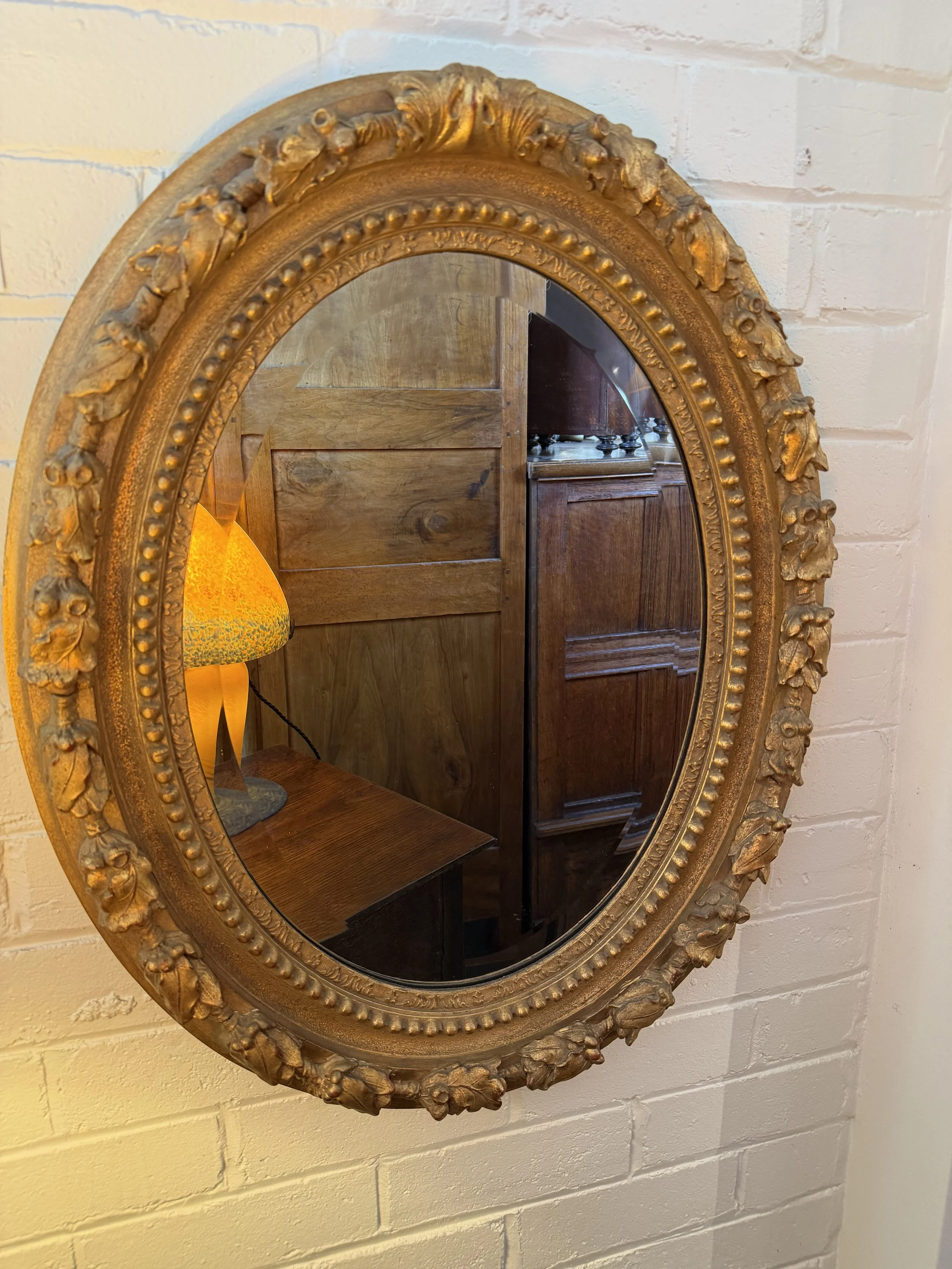 This is a picture of a French Napoleon III period acorn decorated gilt mirror c1860.