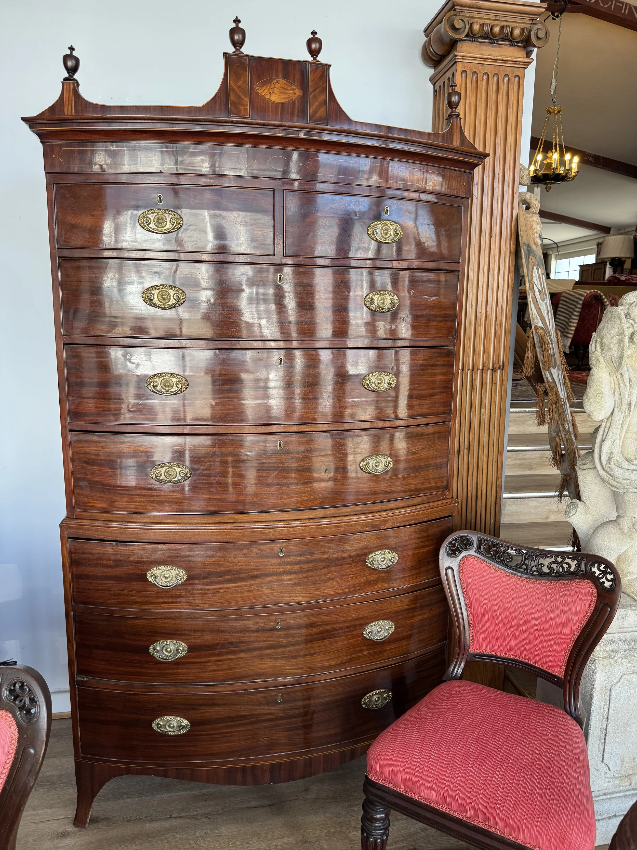 This is a picture of a rare antique Regency period bow front mahogany chest on chest retaining its original handles c1815.