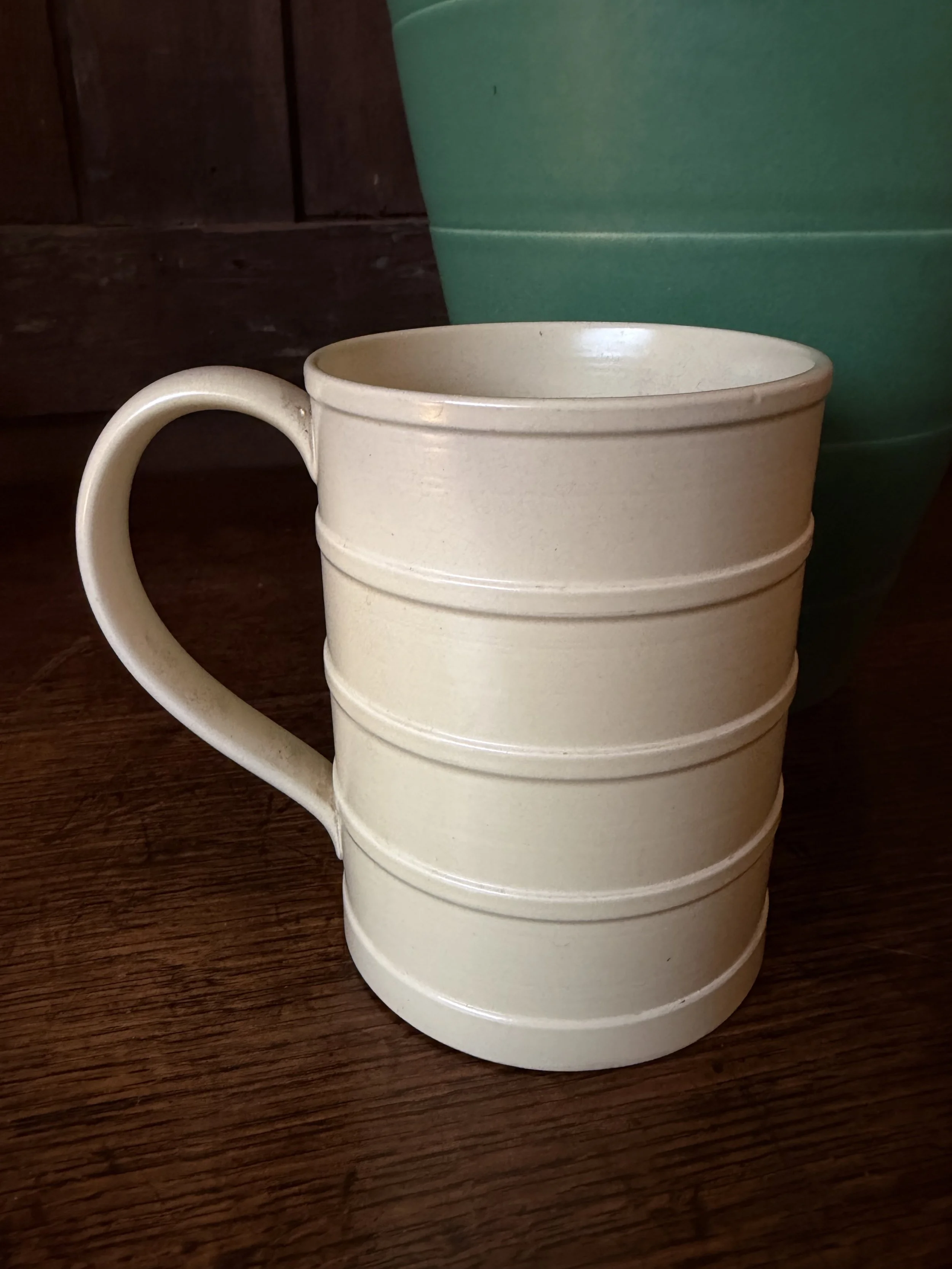 This is a picture of a Keith Murray for Wedgwood Art Deco cream coloured mug c1930.