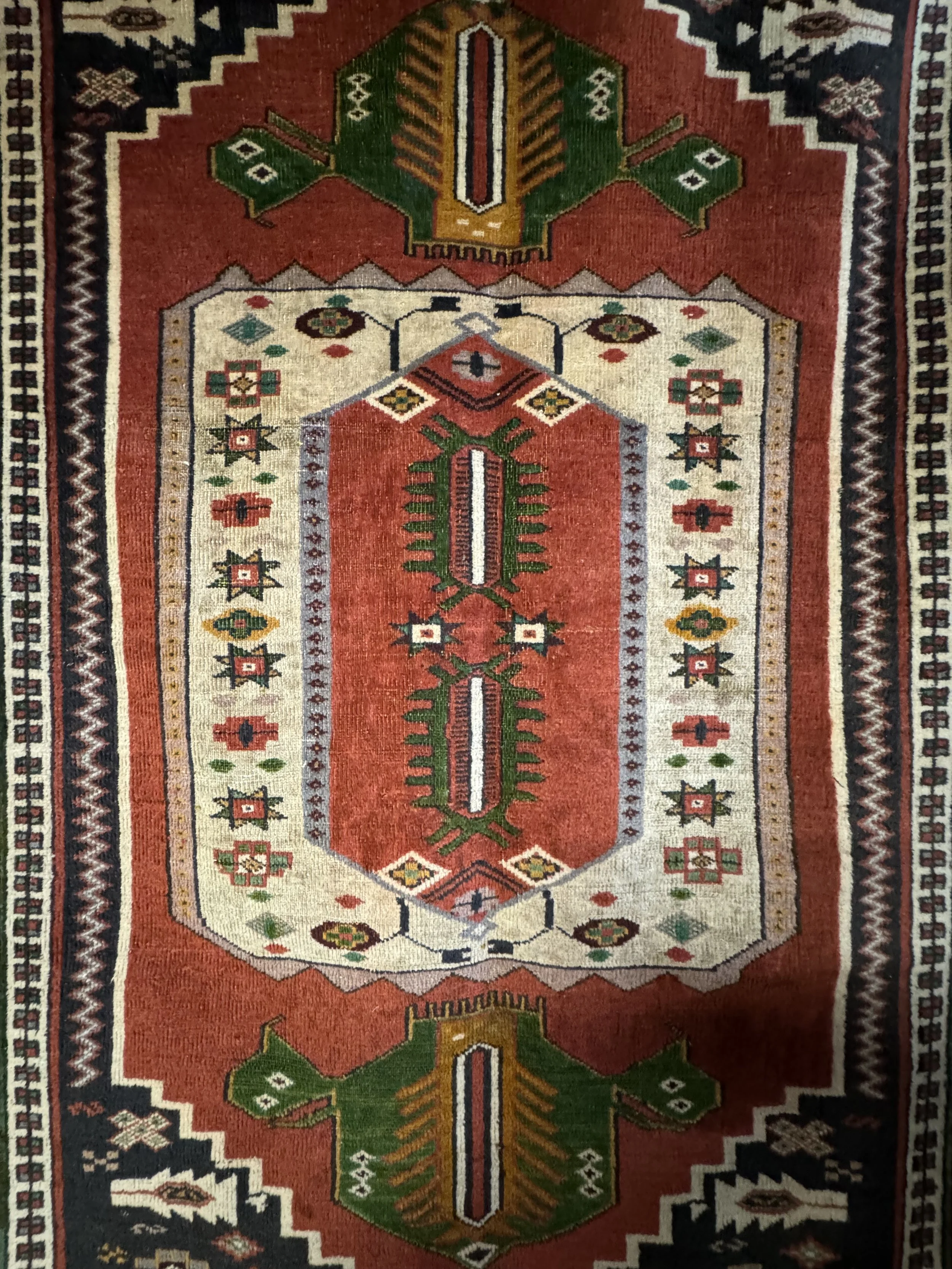 This is a picture of an antique hand knotted wool on wool Caucasian Kazak rug with great colours and design that measures 122cm x 170cm and was made in 1950.