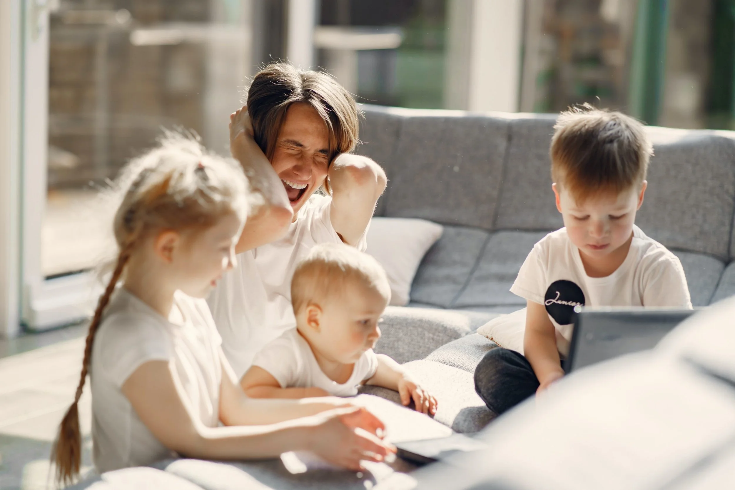 overwhelmed mom feeling frustrated with 3 children representing postpartum rage