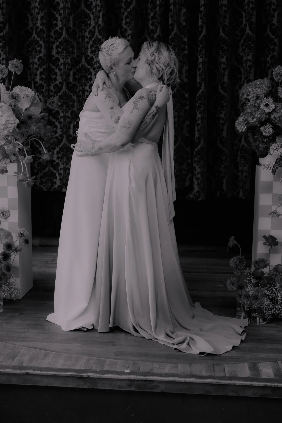 Lesbian couple kissing at the end of their wedding ceremony