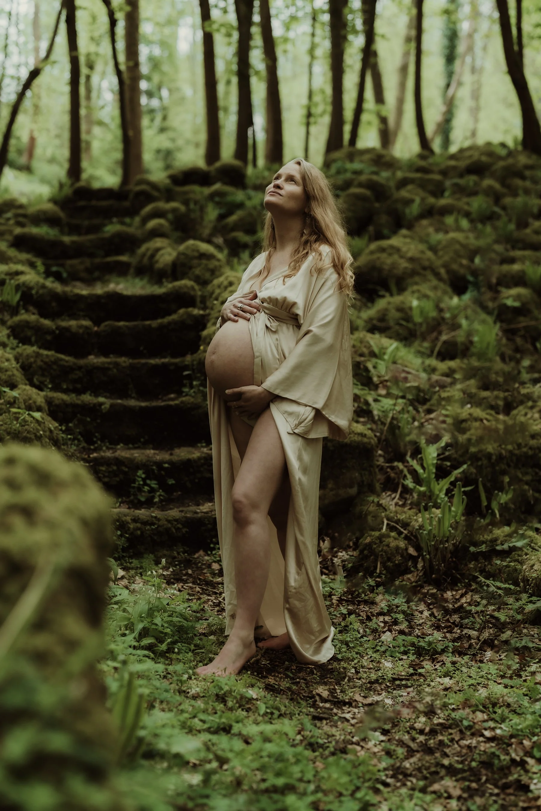 photograph of a pregnant woman in a forest