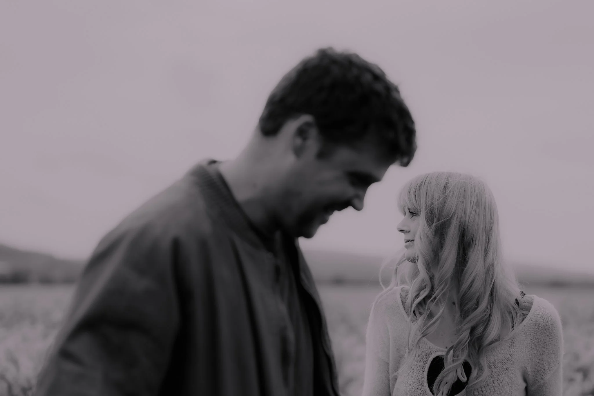 couple photoshoot in wales both partners looking at each other in black and white