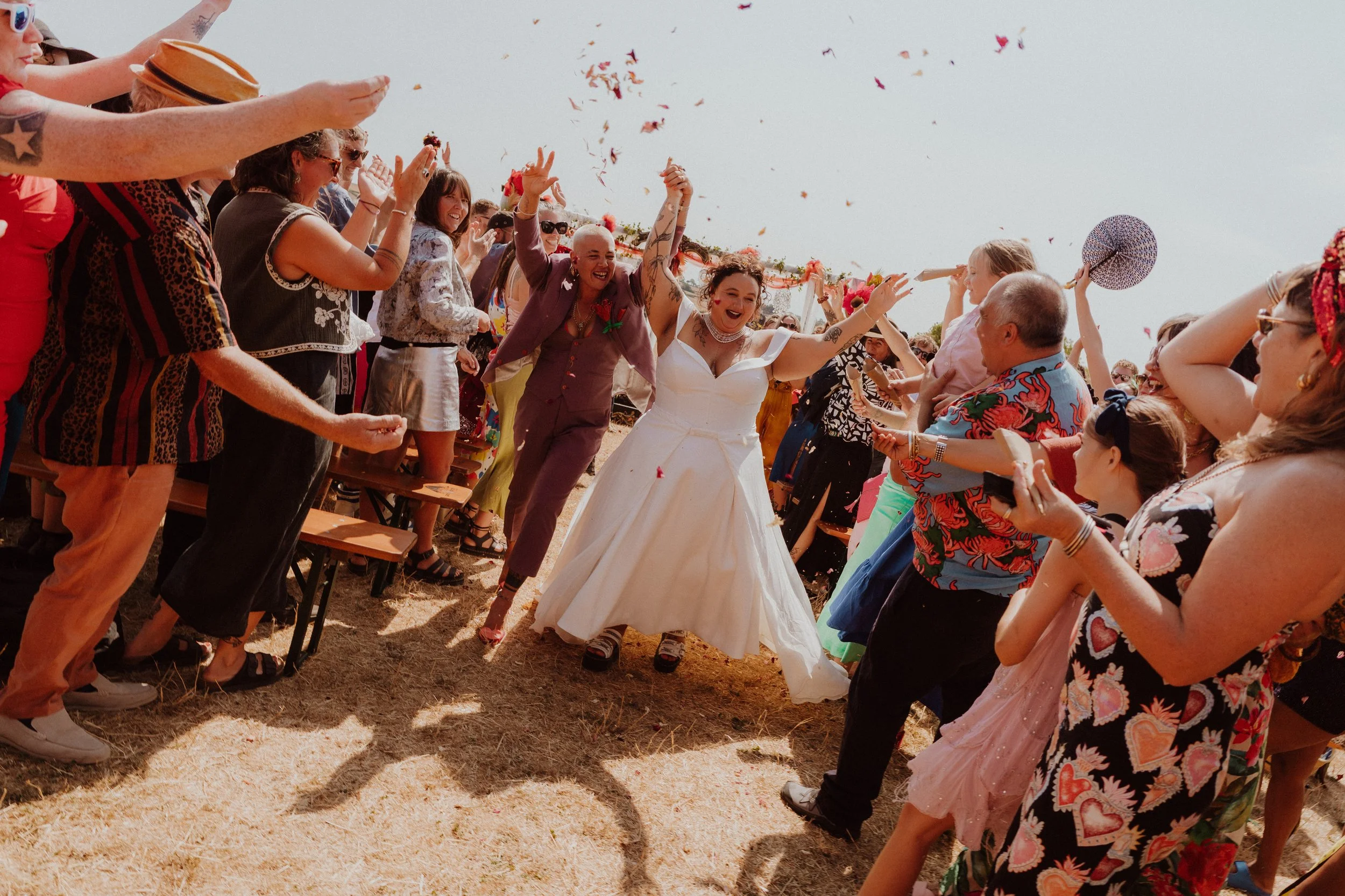 LGBTQIA+ wedding in Bristol - happy brides looking at their wedding magazine together