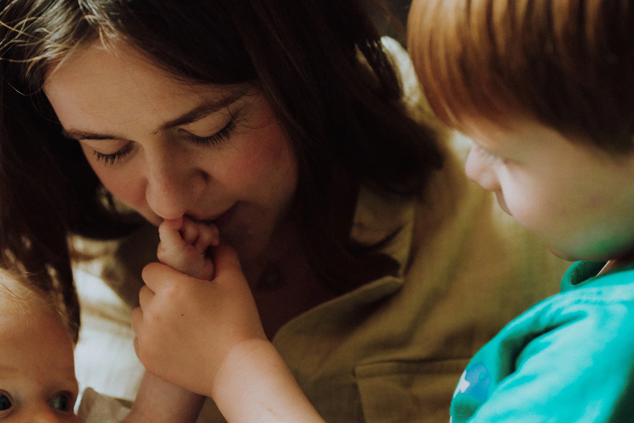 mother kissing the hand of her son