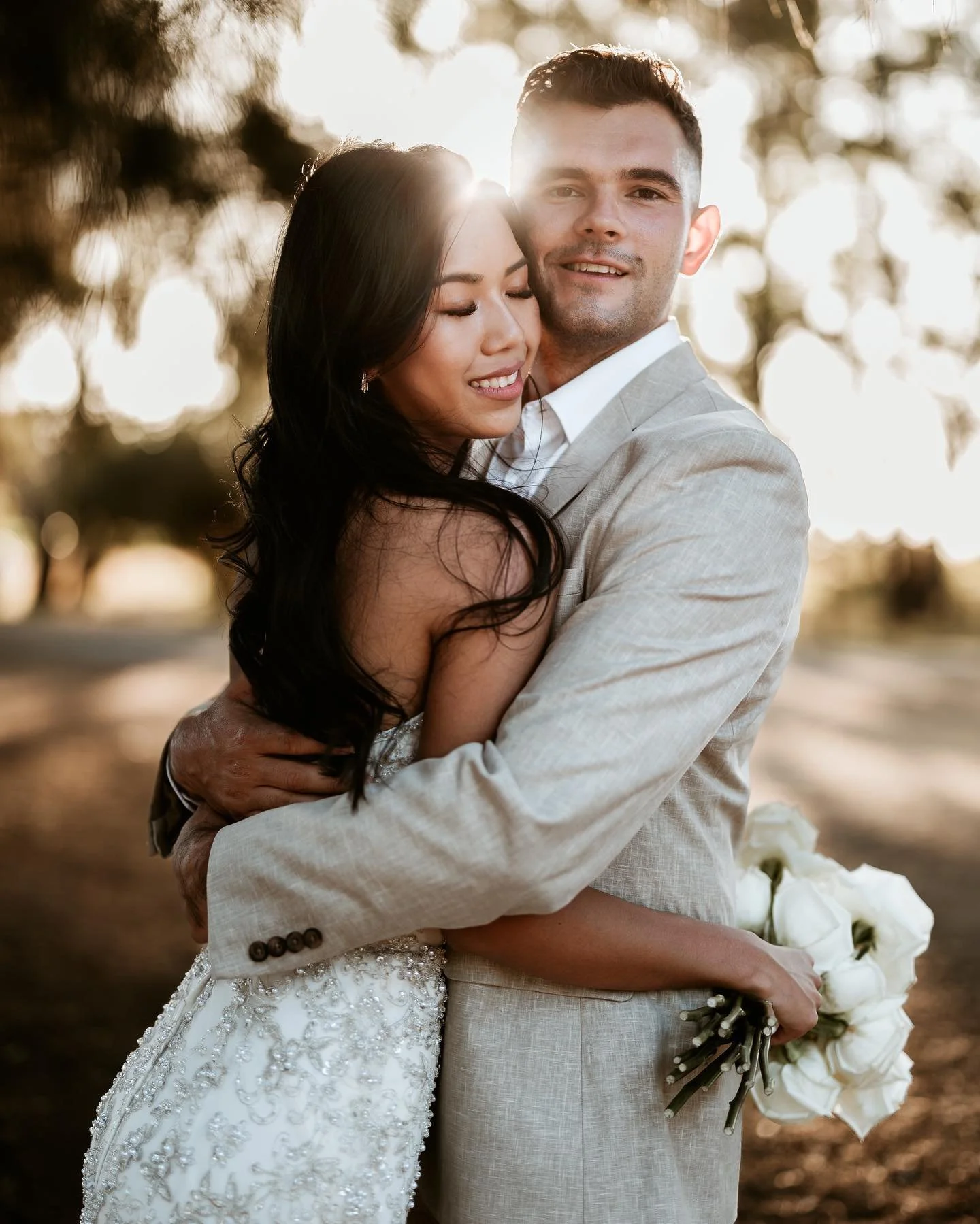 a bride and groom embracing at sunset golden hour at their margaret river elopement