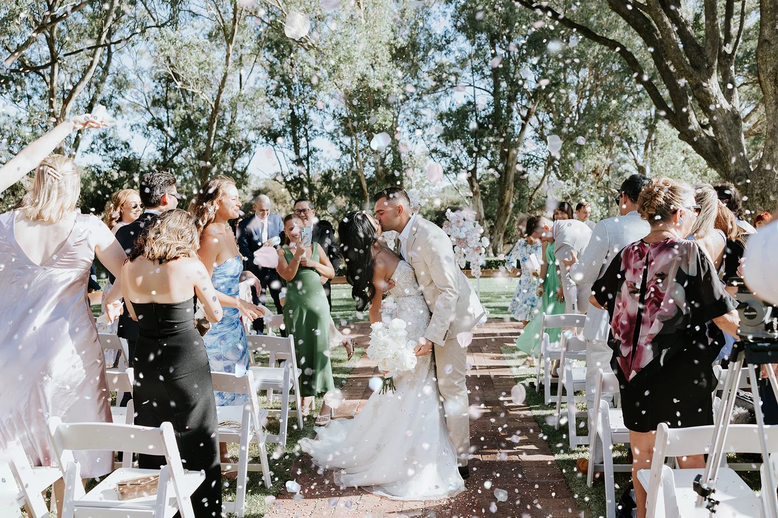 a bride and groom kissing in the aisle surrounded by confetti taken by a swan valley wedding photographer
