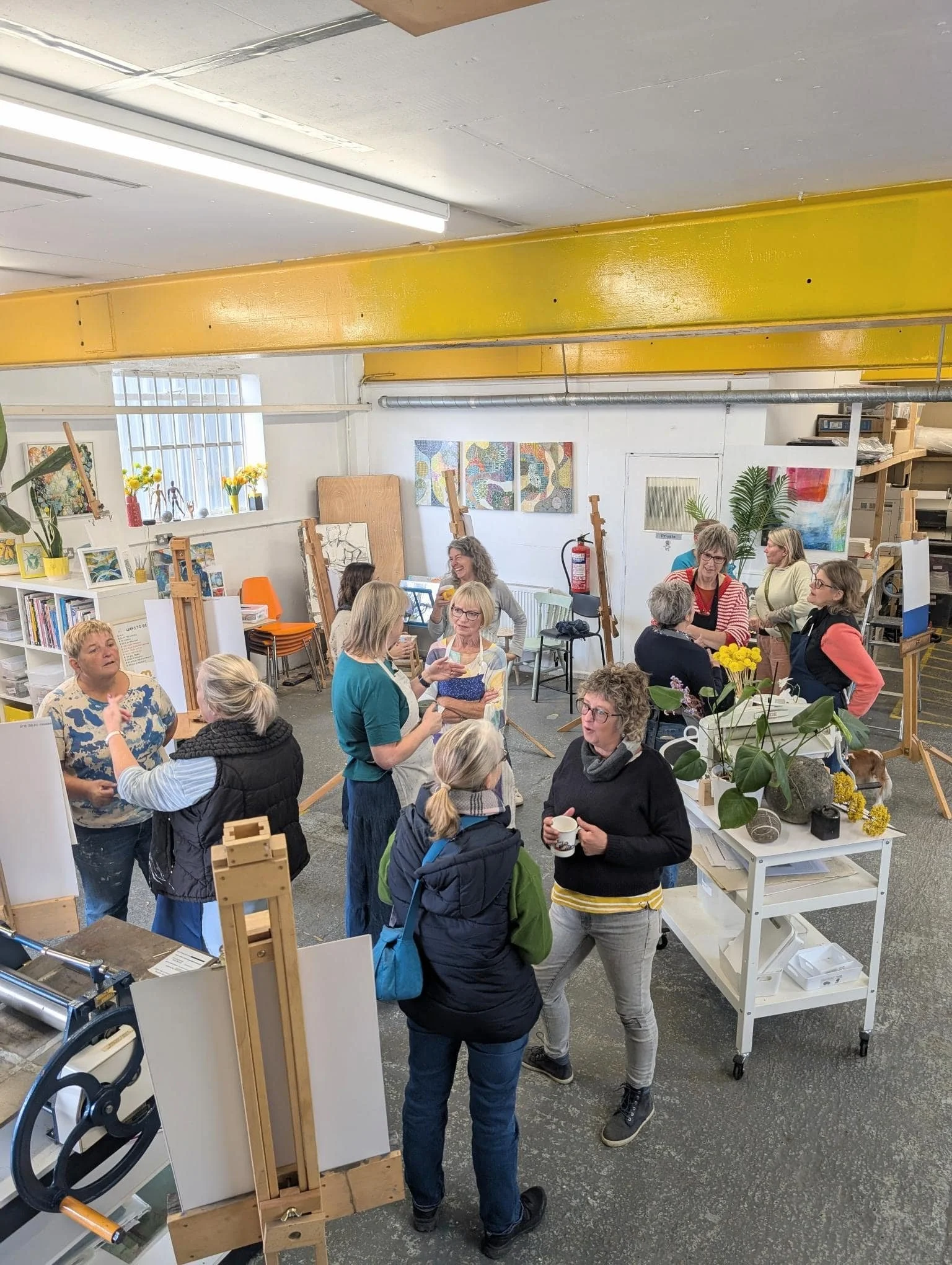 Students painting abstract art in studio