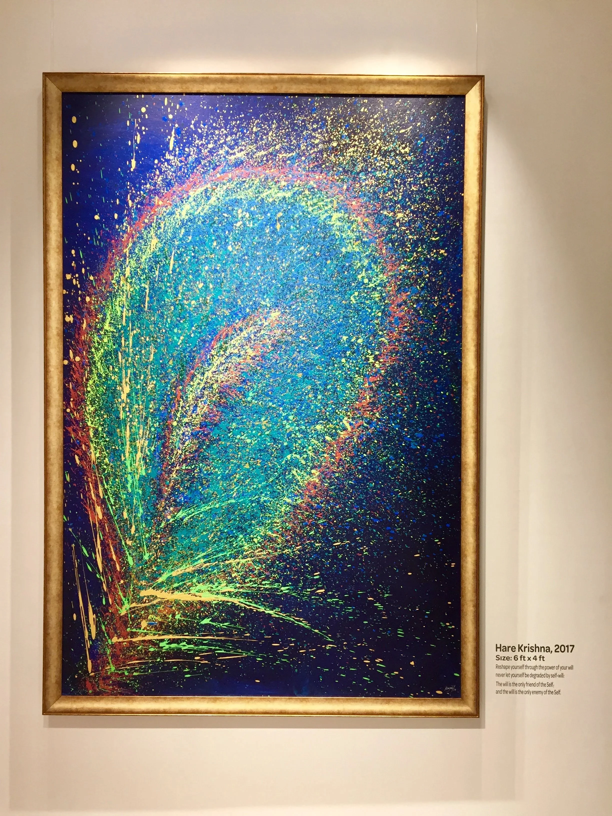 Colorful abstract painting of a peacock feather by Hare Krishna, 2017, with a gold frame