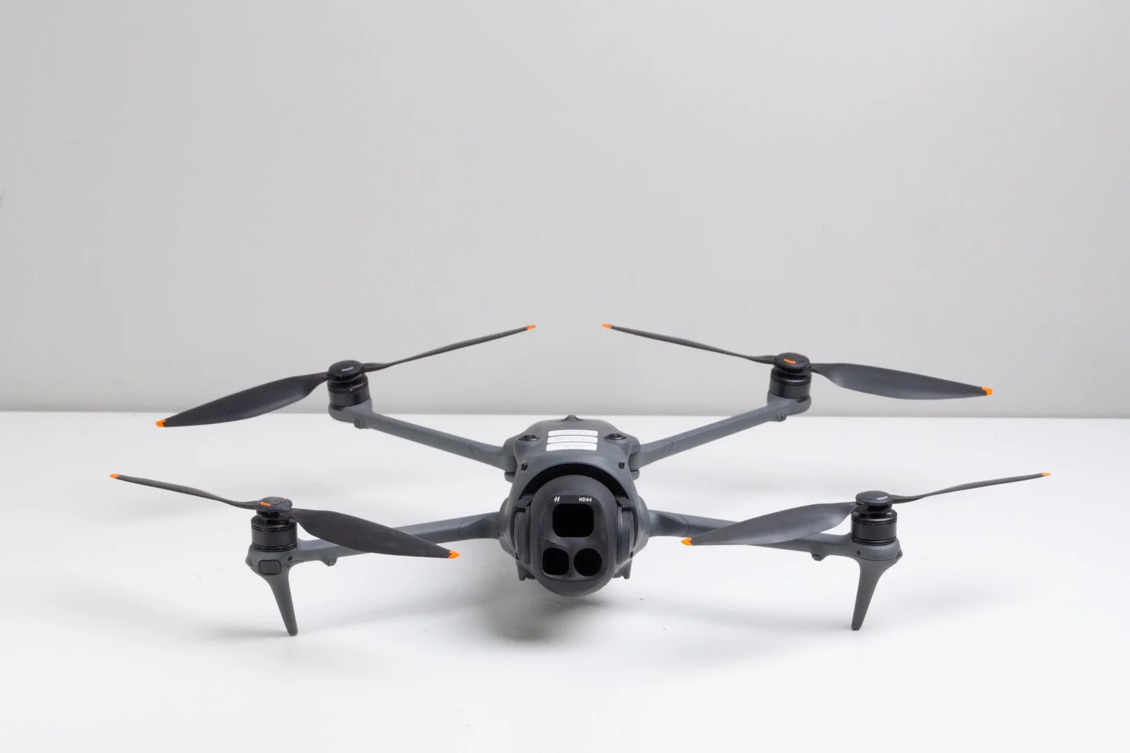 A gray DJI Mavic 4 Pro drone placed on a white surface against a plain gray background.