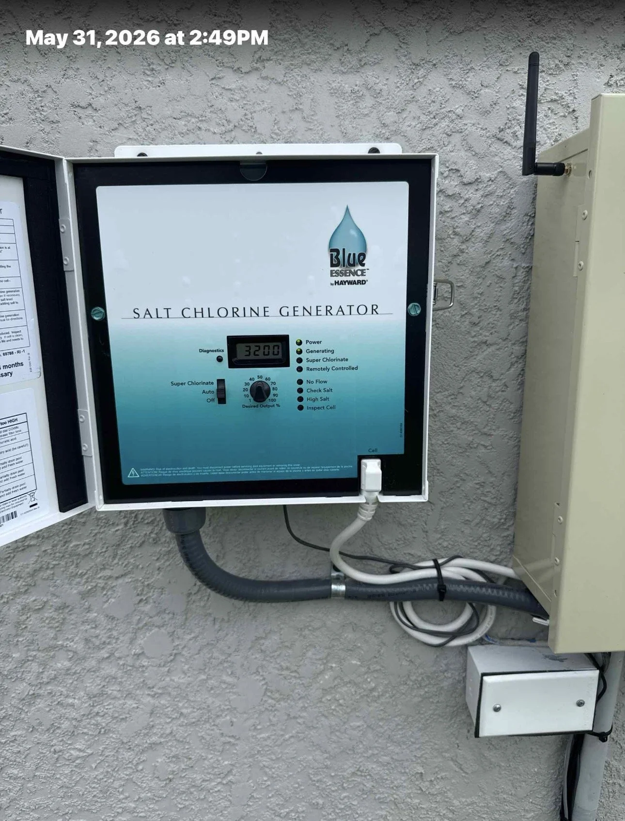 A salt chlorinator control system mounted on a wall, showing a digital display reading 3200, with labels indicating functions such as power, generating, super chlorinate, and diagnostics.
