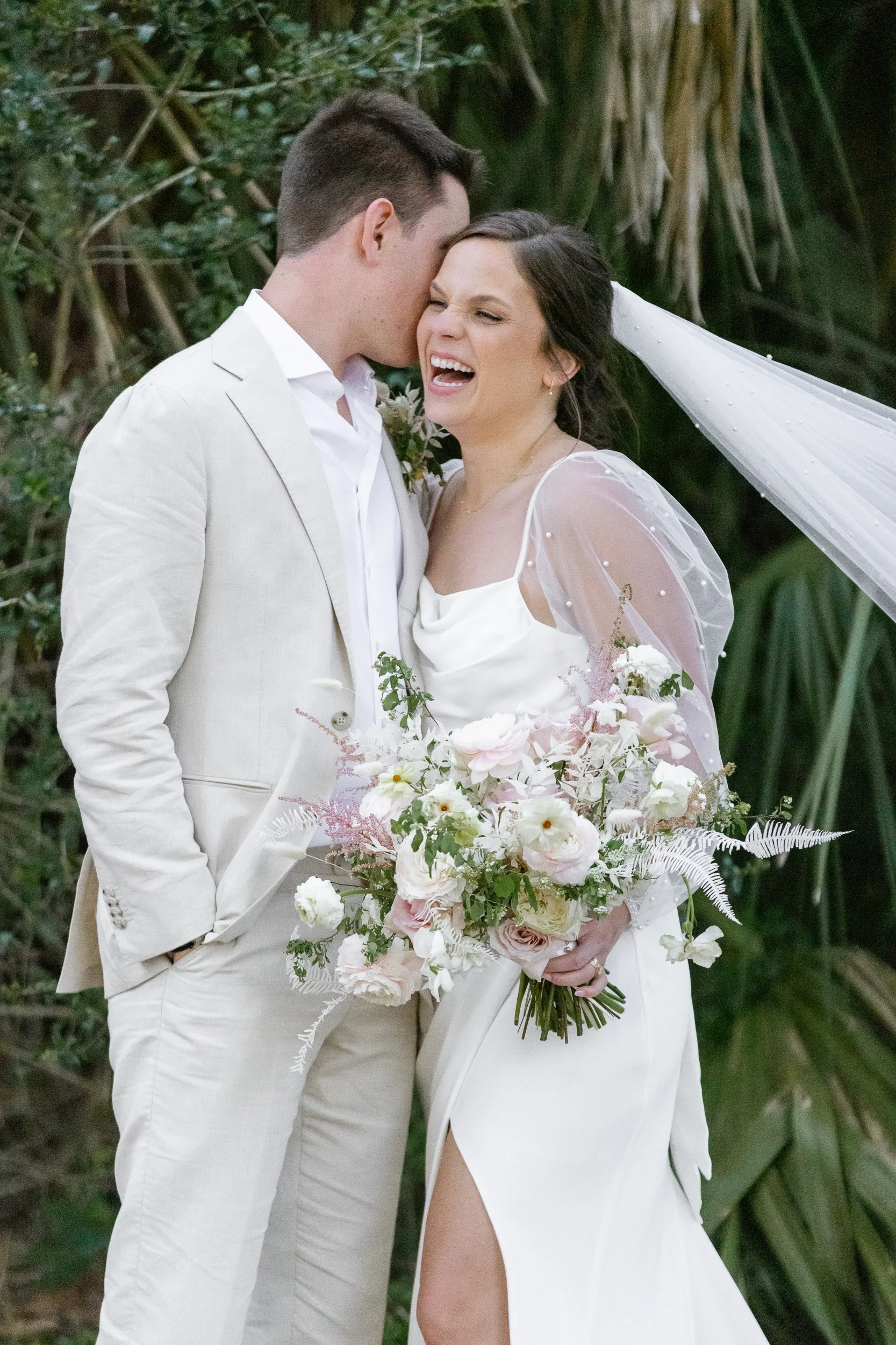 A bride and groom sharing a kiss outdoors during intimate wedding in Greenville, SC