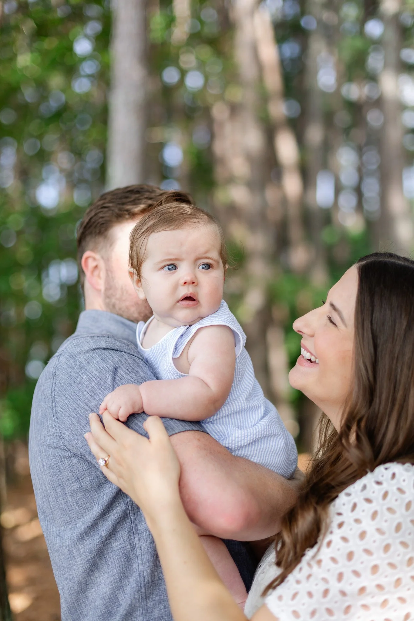 Mother and father holding baby boy mother smiling at her son photoshoot by Rios Tegen photography in Clemson SC