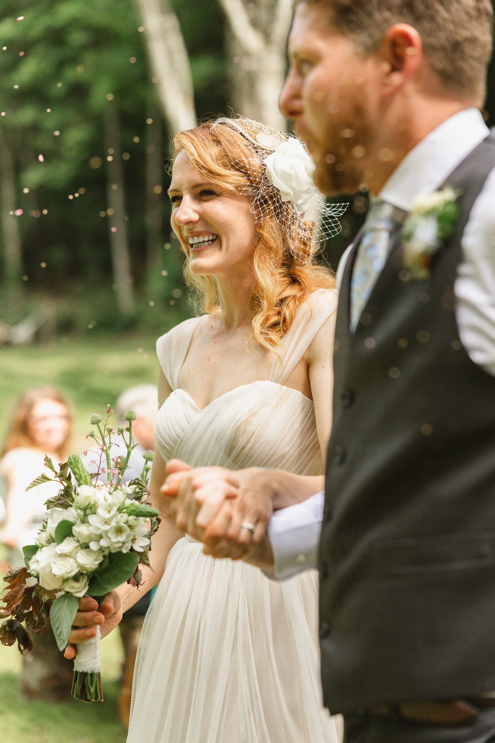 A bride and groom holding hands during an outdoor wedding ceremony in Greenville, SC