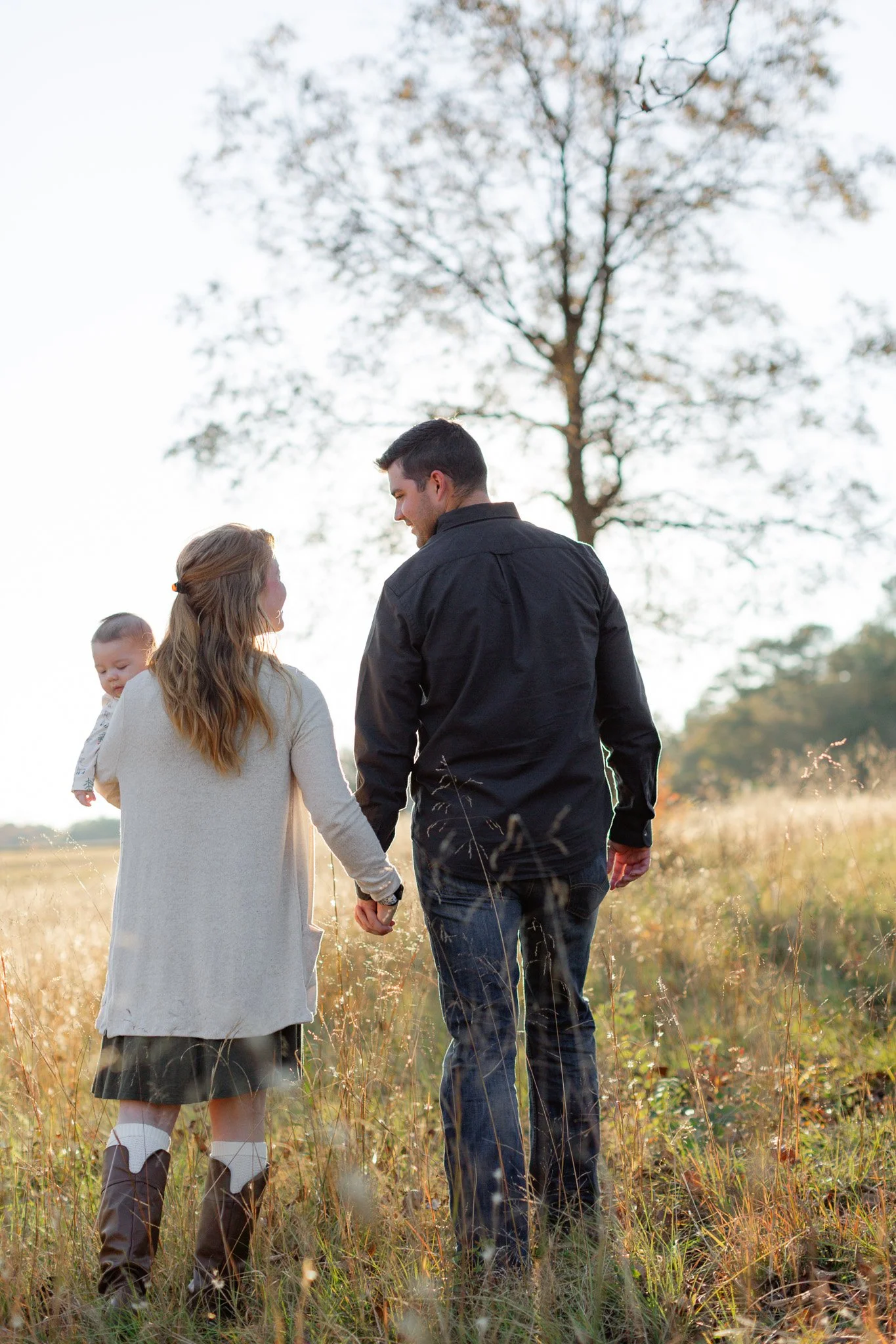 A family walking at sunset in field, Clemson SC family photography session.