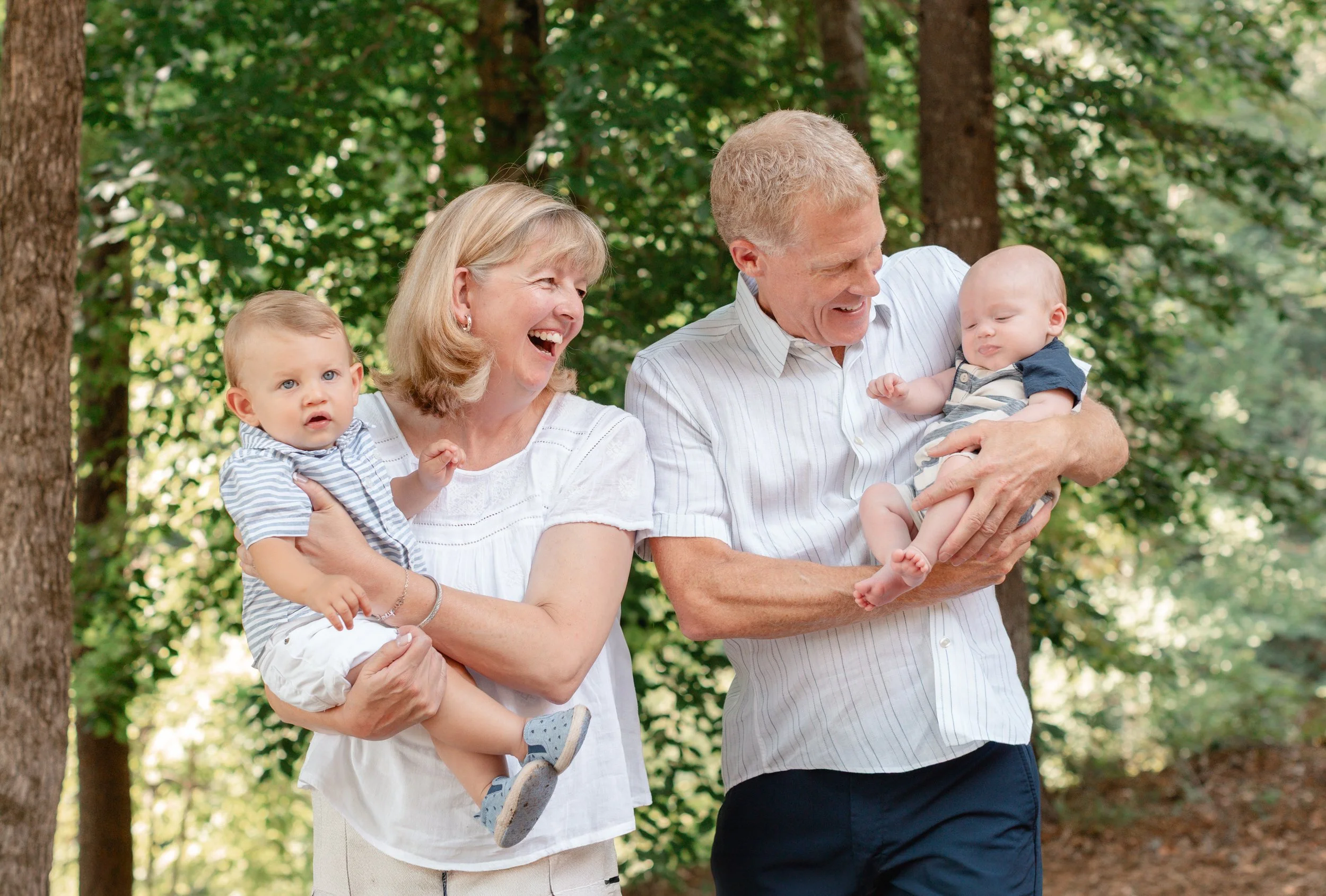 Grandparents holding grandchildren during photo session at Lake Keowee