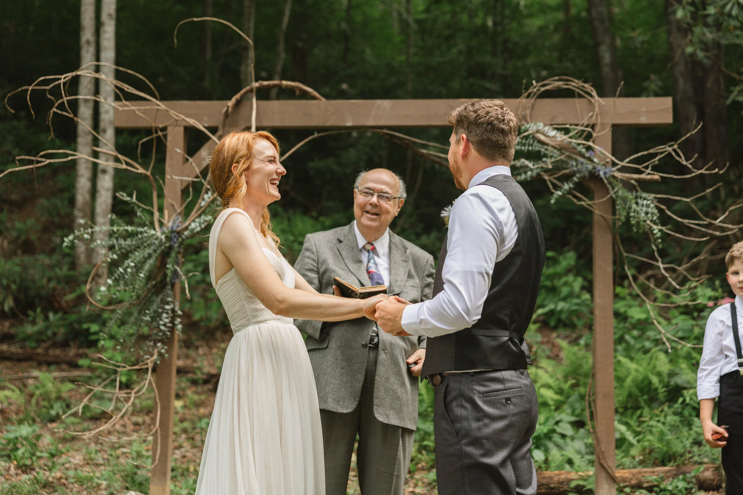A couple exchanging vows during a wedding ceremony outdoors in backyard wedding in Clemson SC.