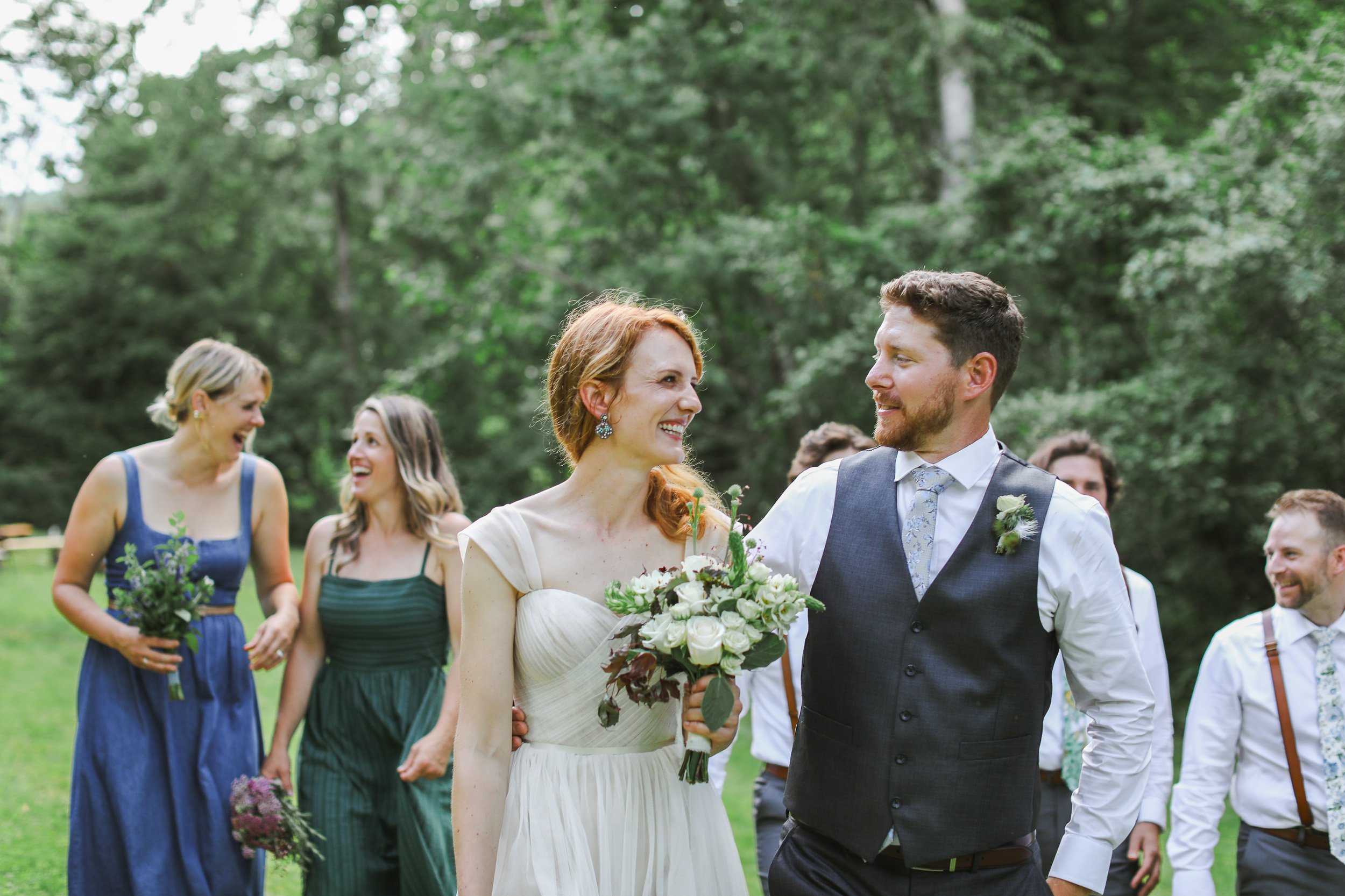 A bride and groom smiling at each other during their outdoor wedding reception in Greenville, SC