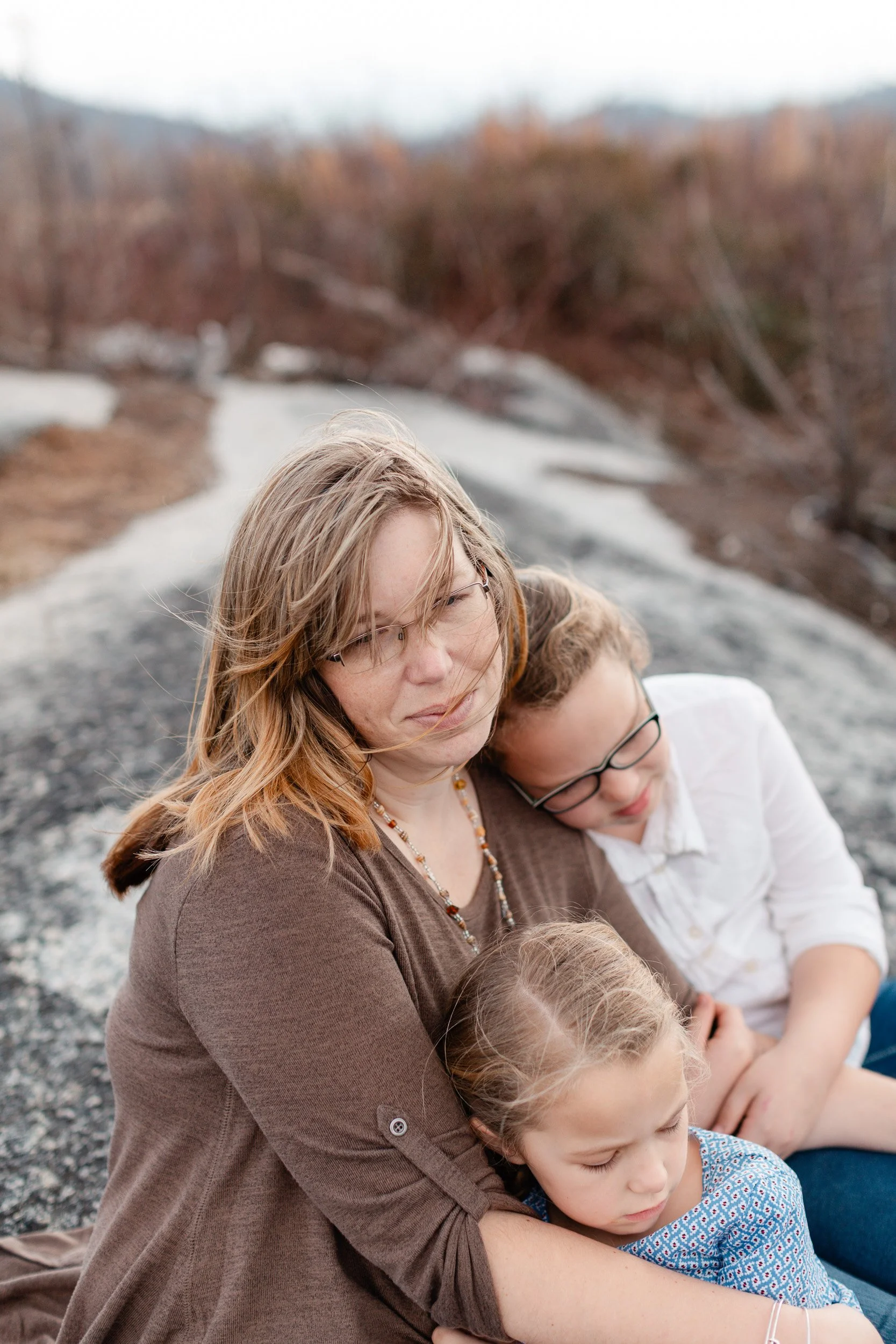 Mother and two daughters embracing during mountain photoshoot in Greenville SC