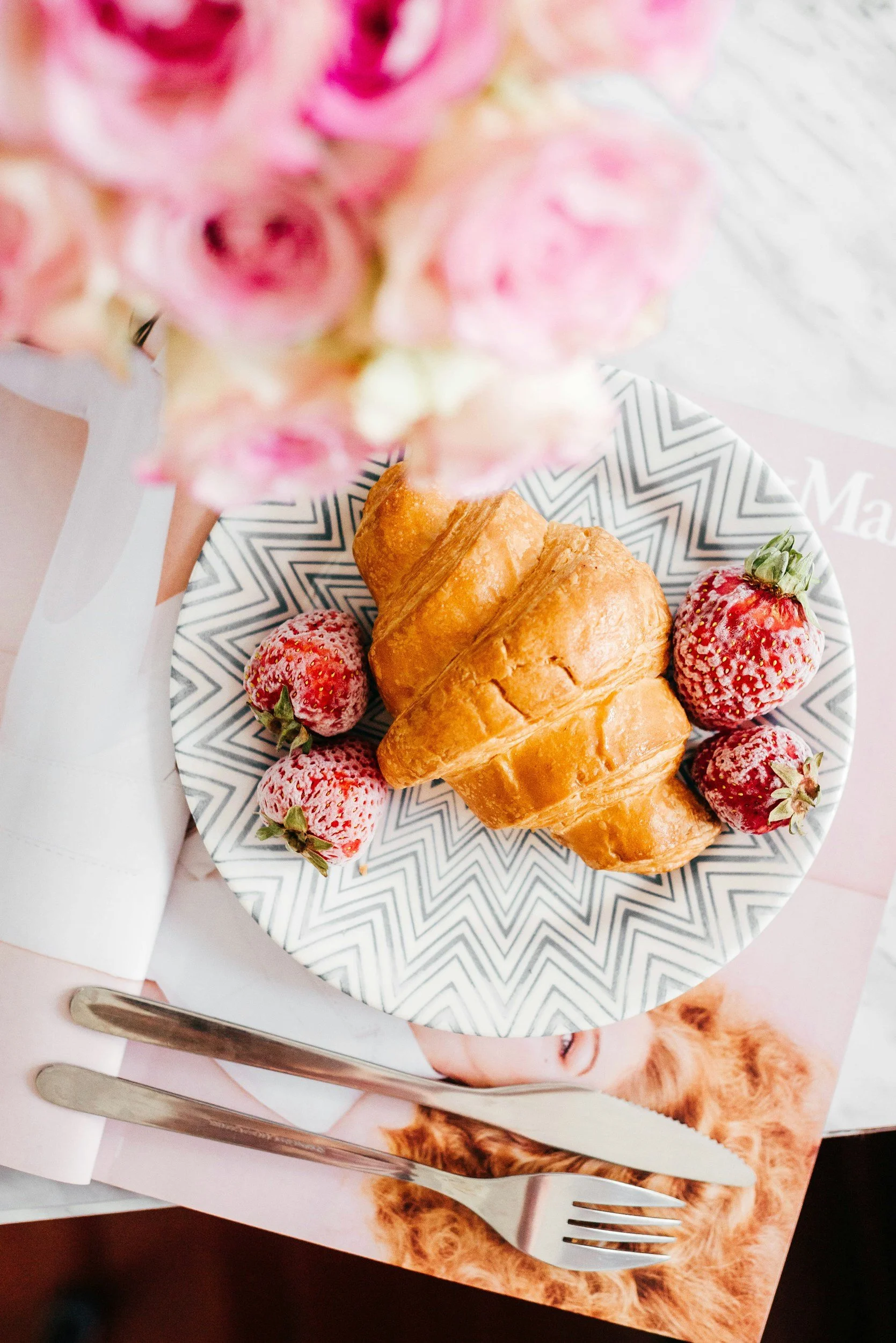 A romantic breakfast with croissants, strawberries, and flowers — the perfect slow morning in Savannah.