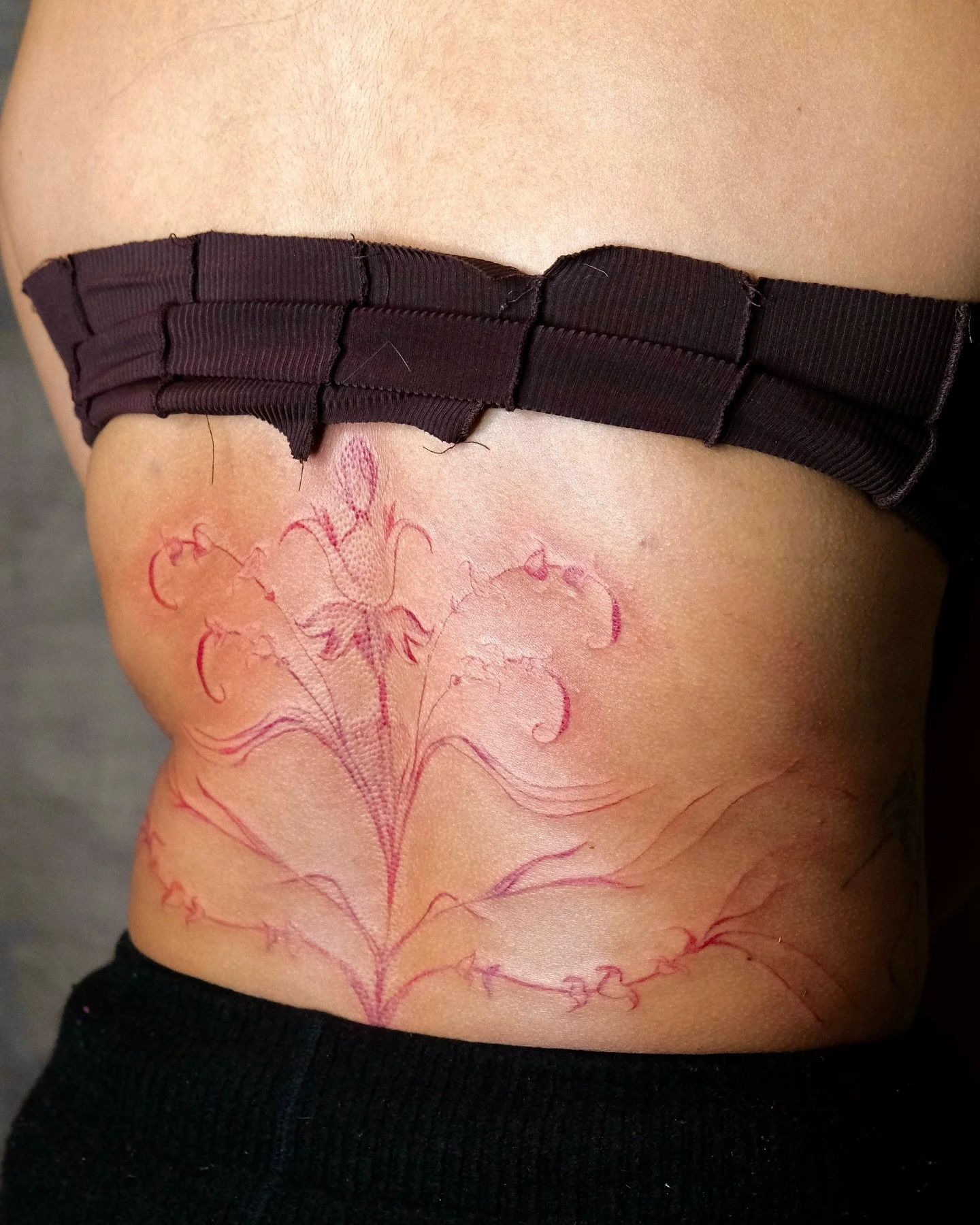 🖤 in progress lower back piece ⛓️ 

Progress photo - outline done in red ink. Super excited when i have people that come to me with their ideas, and always down to try something new.

This was done in one session, and in the second we will focus on 