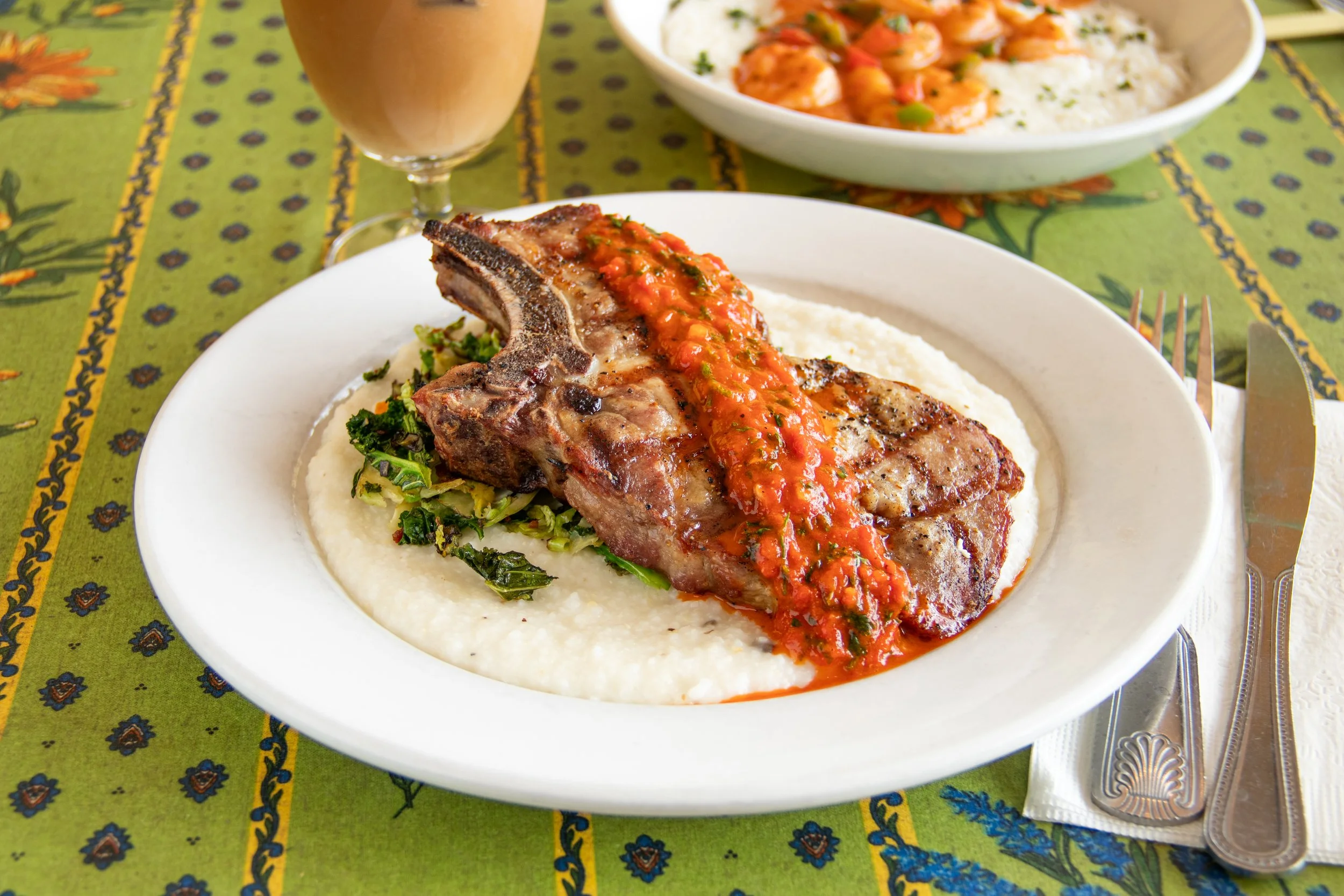 Grilled Pork Ribeye on grits with red Chimichurri