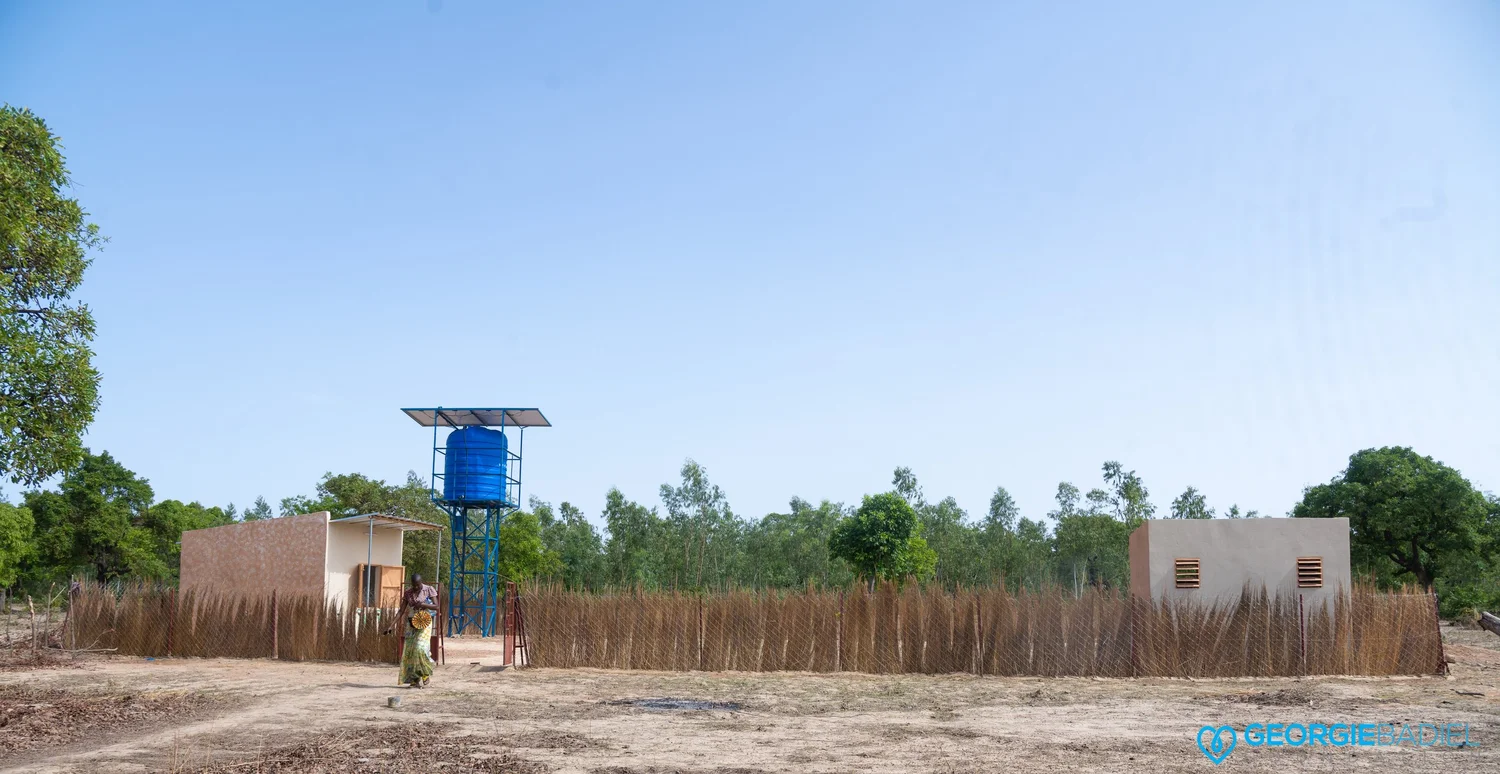 Community oasis with water point, gardens, and study space