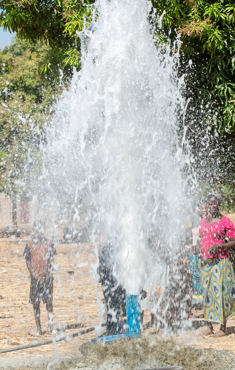 Crew drilling a new village well