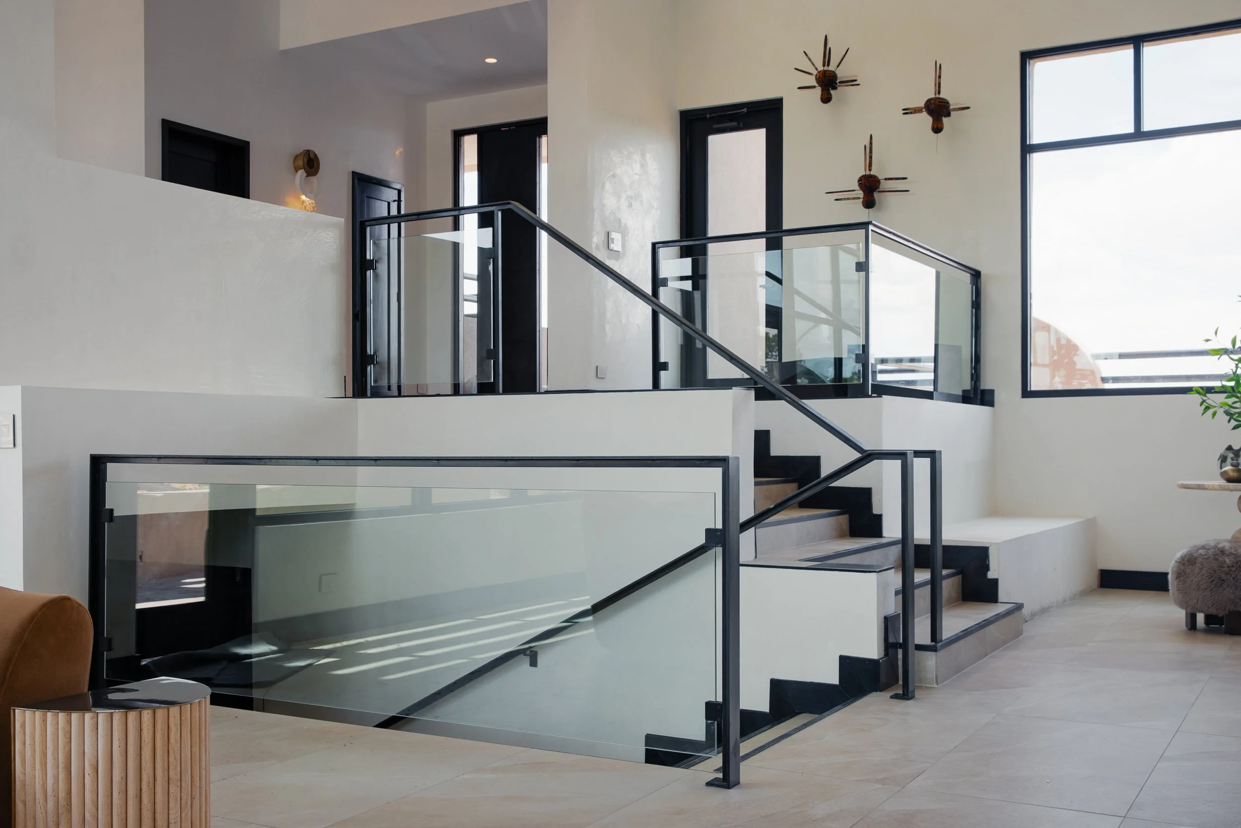 Custom railing, fireplace mantels, hearths, screens, entry door, wine cabinetry, wine room doors